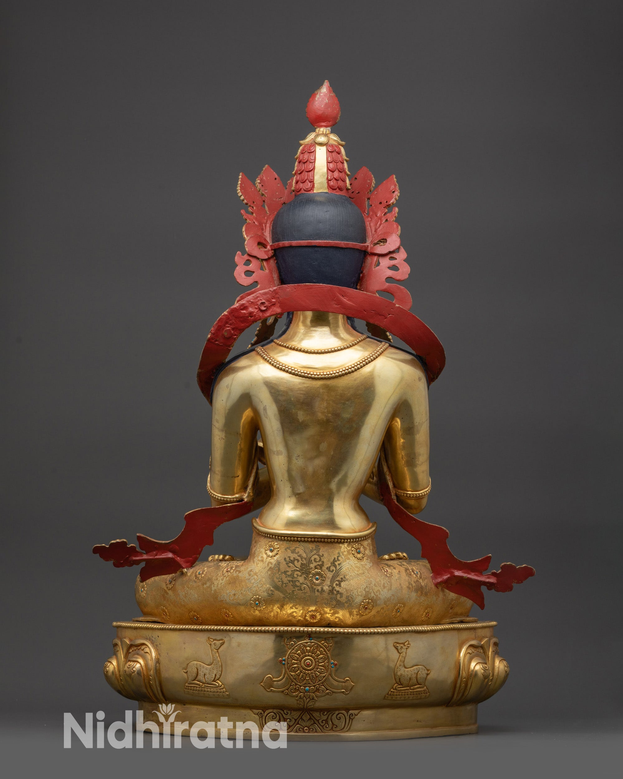 Back view Vajradhara statue featuring deer carvings and Dharma wheel symbolism