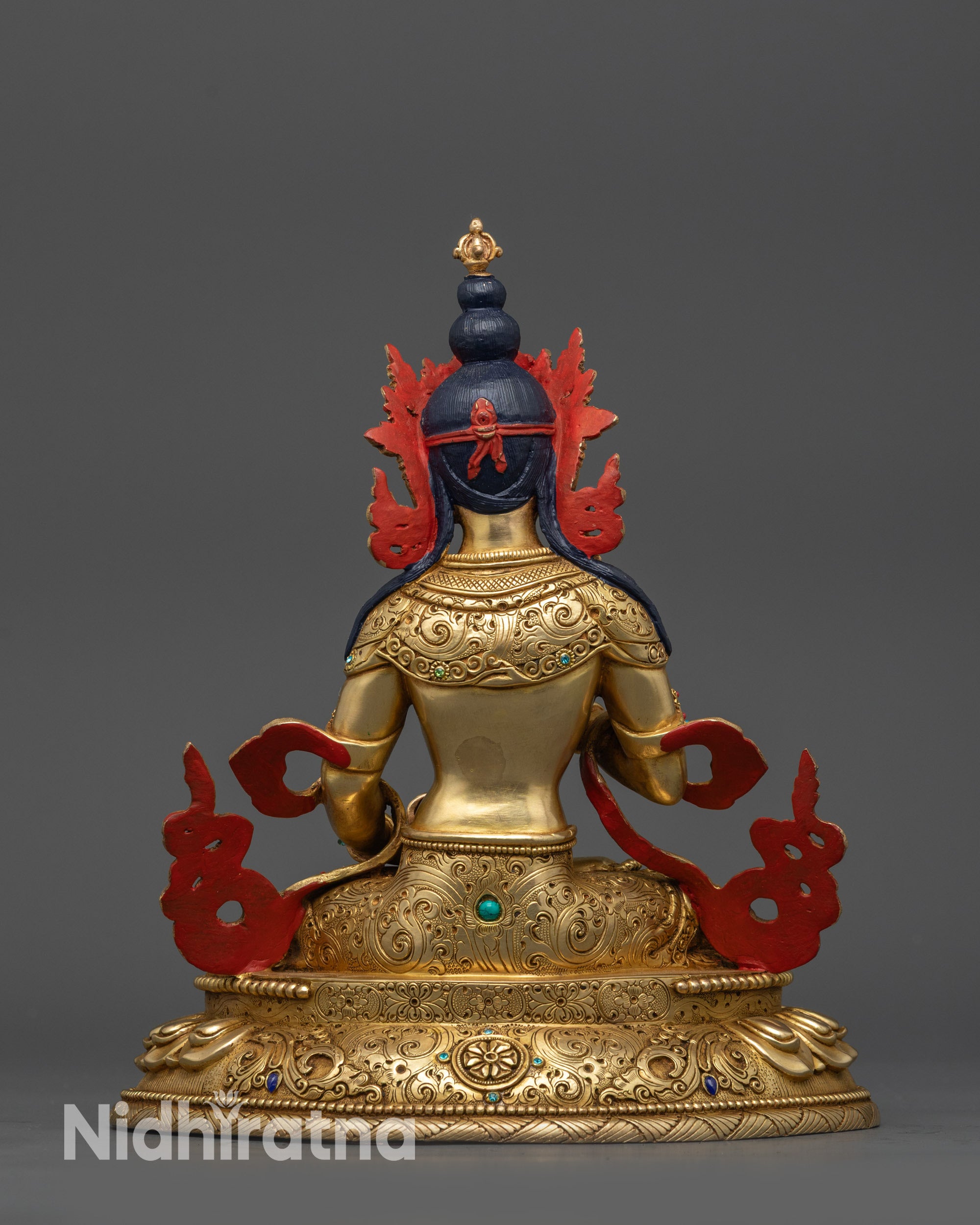 Back view Vajrasattva on lotus seat with intricate carved jewelry and patterns