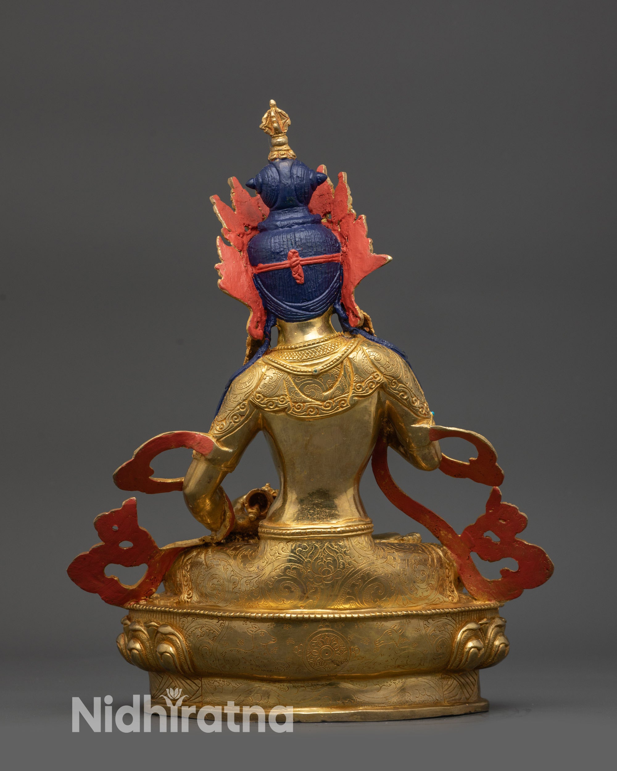 Back view Vajrasattva statue displaying lotus seat and intricately carved robes