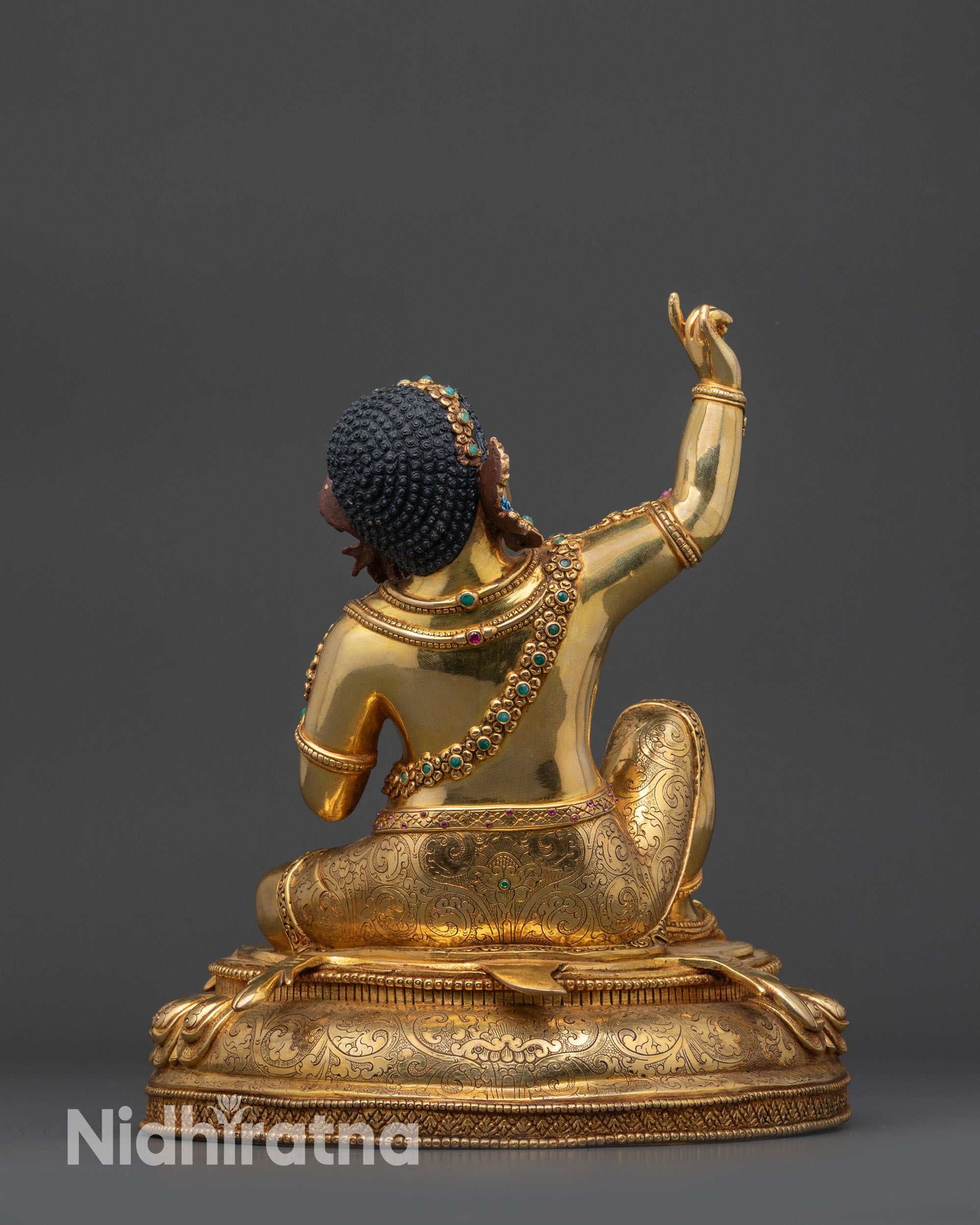 Back view Virupa Statue showing intricate carvings and gemstone-adorned ornaments