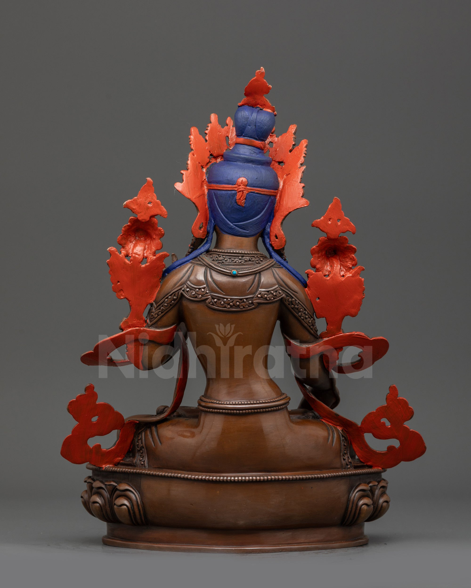 Back view White Tara oxidized statue displaying carved robe and patterned double-lotus seat