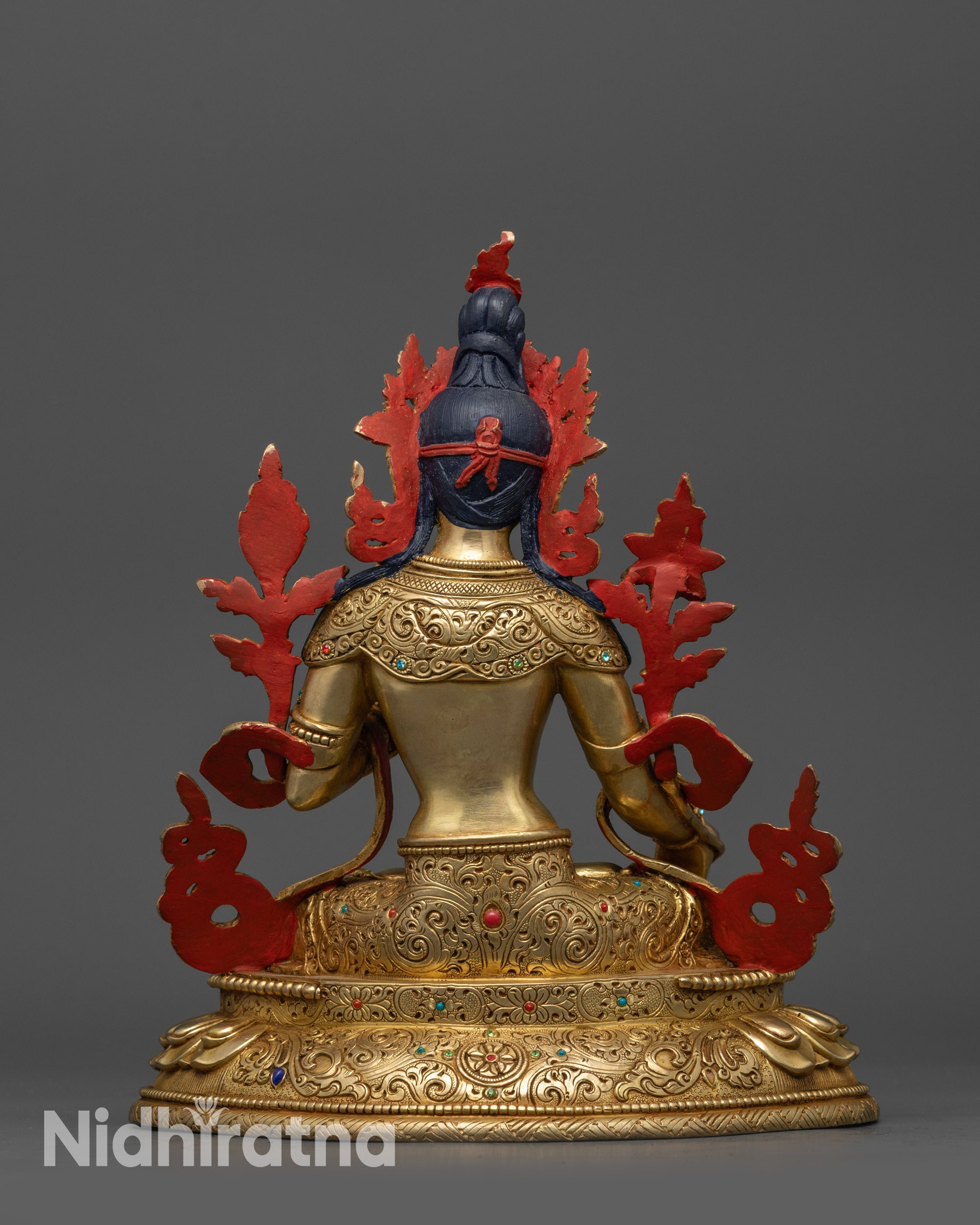 Back view White Tara statue highlighting detailed patterned jewelry on lotus base