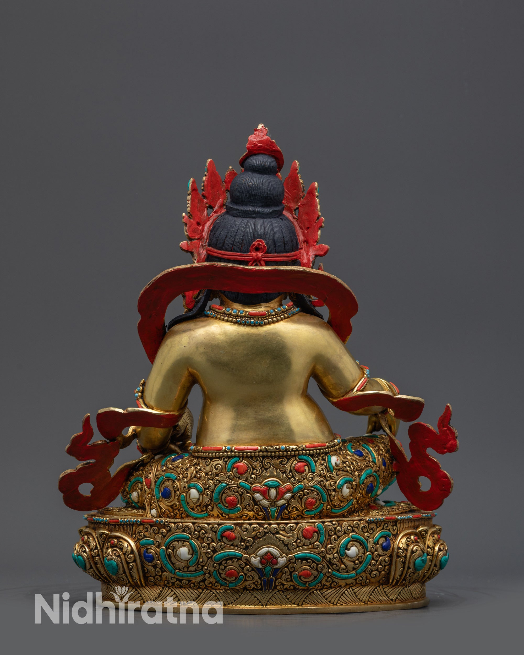 Back view Yellow Dzambhala Statue showing embossed robe and lotus base details