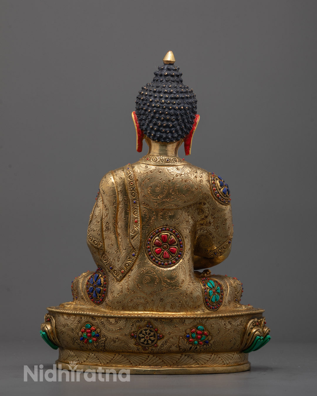 Back view of Amitabha Buddha sculpture showing detailed robes and hollow chamber