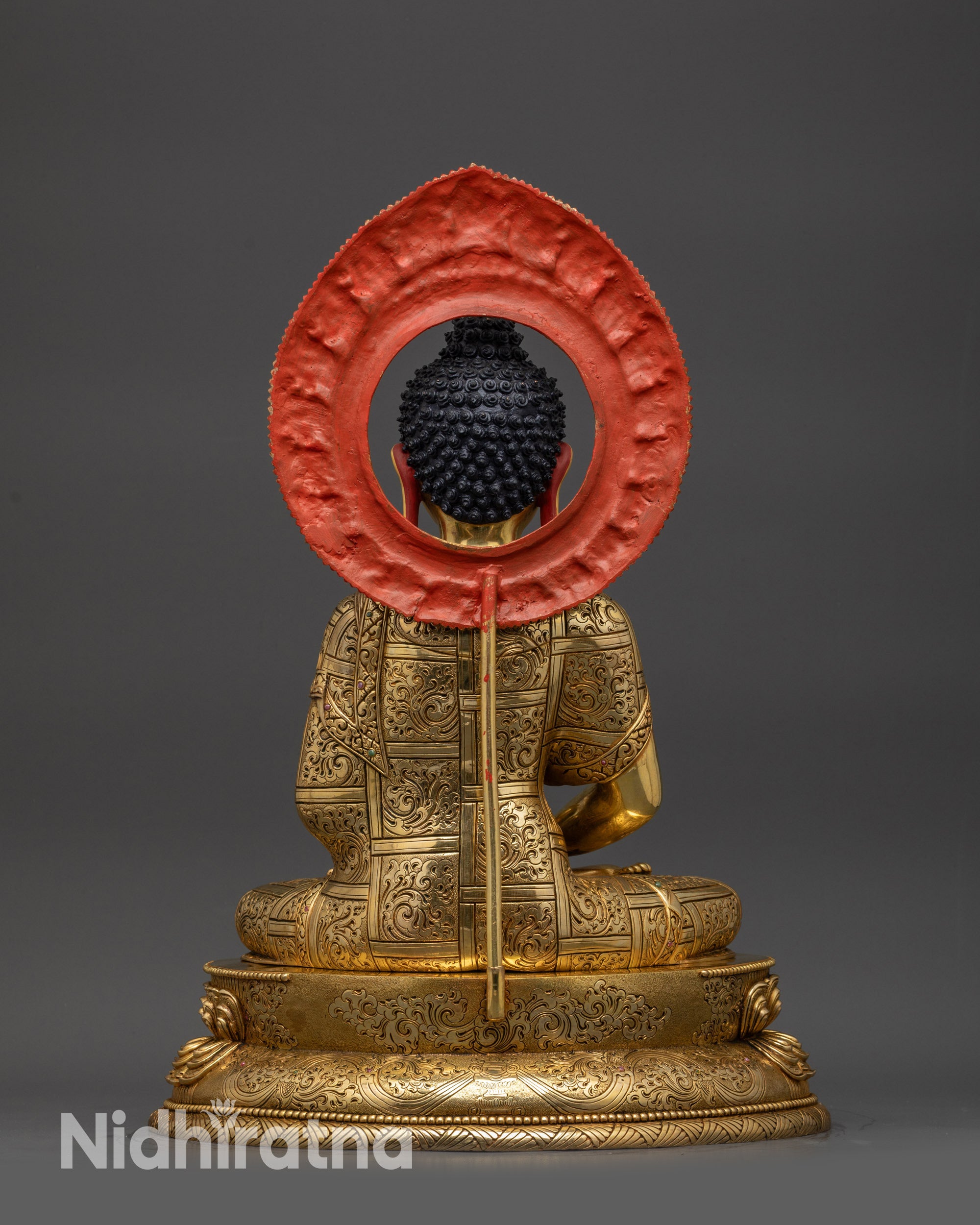 Back view of Amitabha Buddha statue highlighting carved robe patterns and lotus base