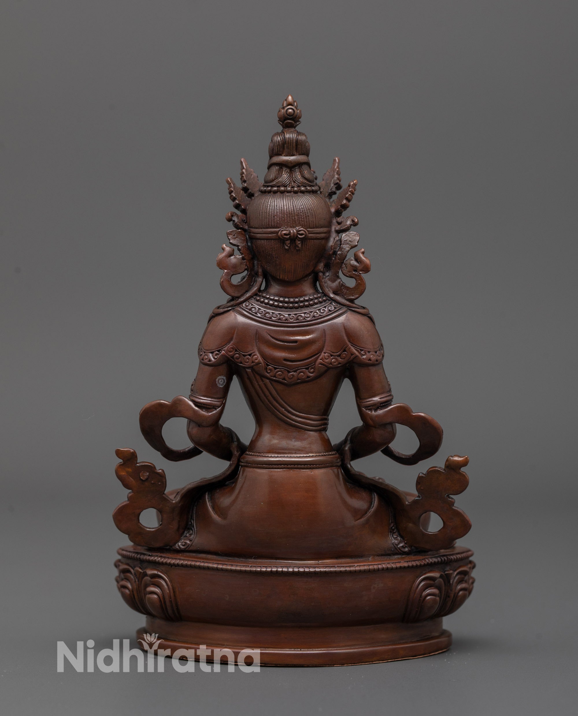 Back view of Amitayus Statue highlighting craftsmanship and smooth oxidized copper surface