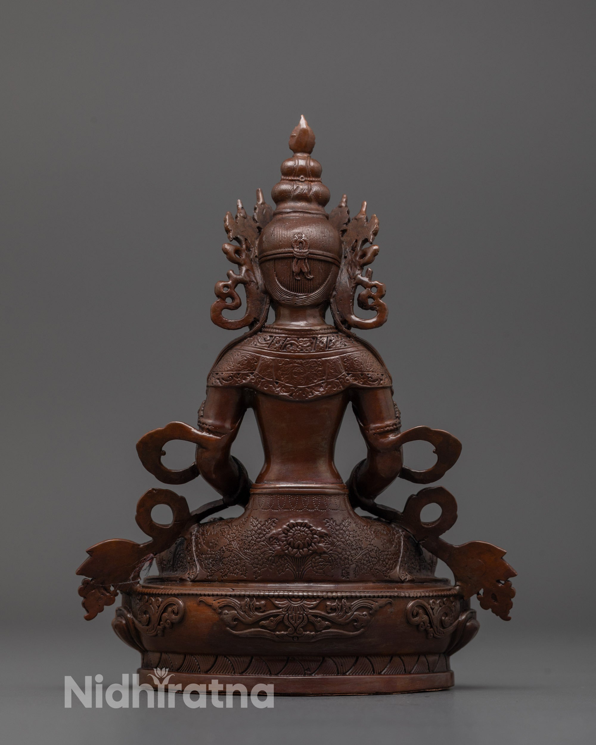 Back view of machine-crafted Amitayus statue with uniform oxidized copper and smooth finish