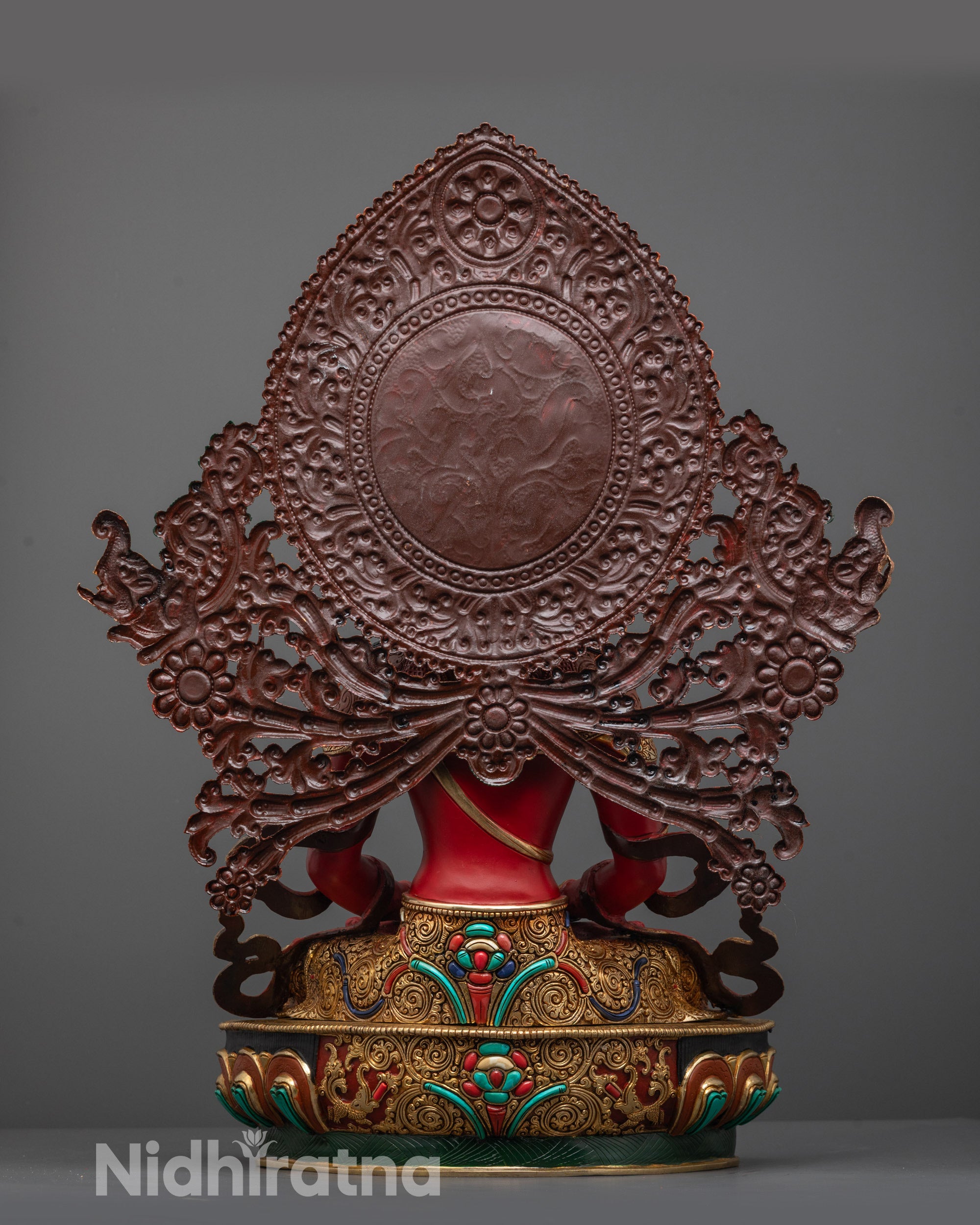 Back view of Amitayus statue showing halo, detailed carvings, and embedded semi-precious stones
