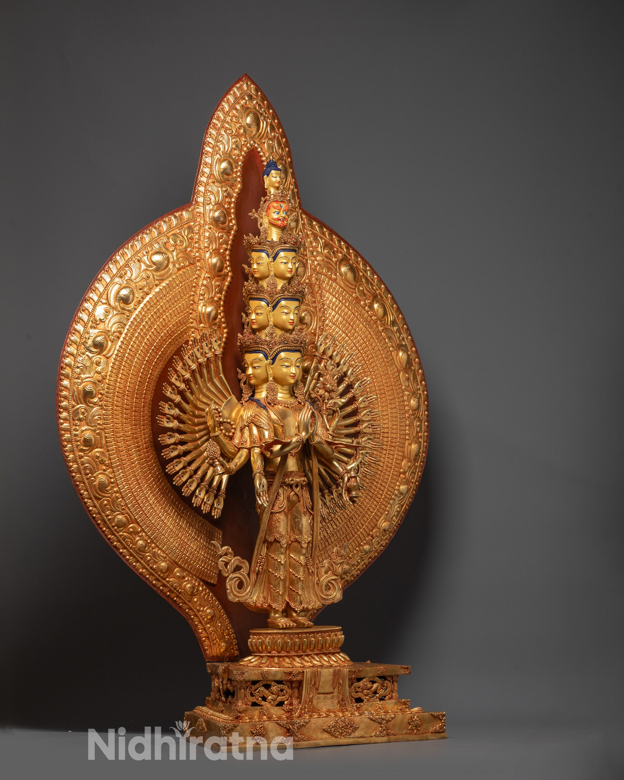 Back view of Avalokiteshvara sculpture highlighting carved arms, intricate patterns, and halo