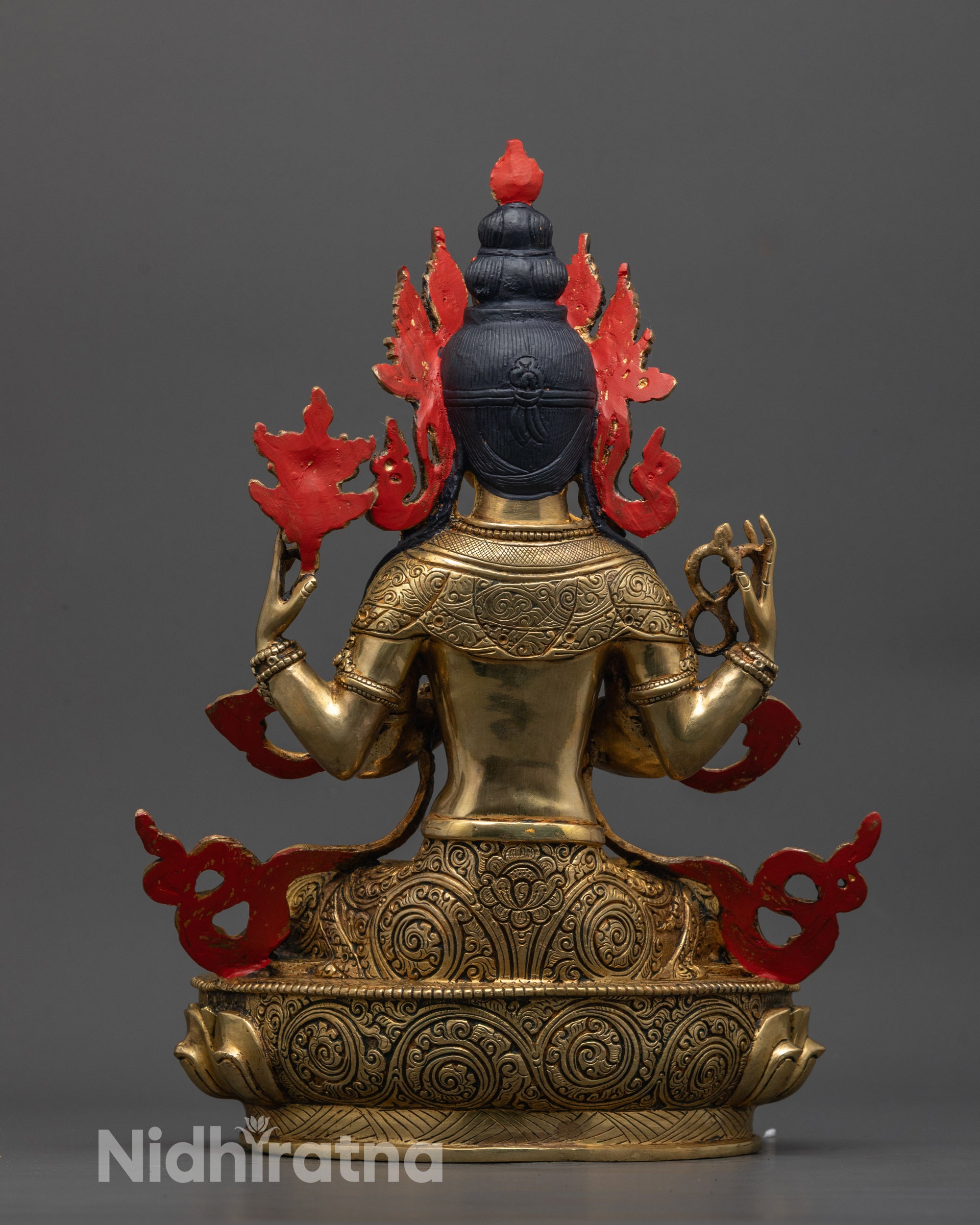 Back view of Avalokiteshvara statue with detailed carvings on lotus base and gold fire-gilded body