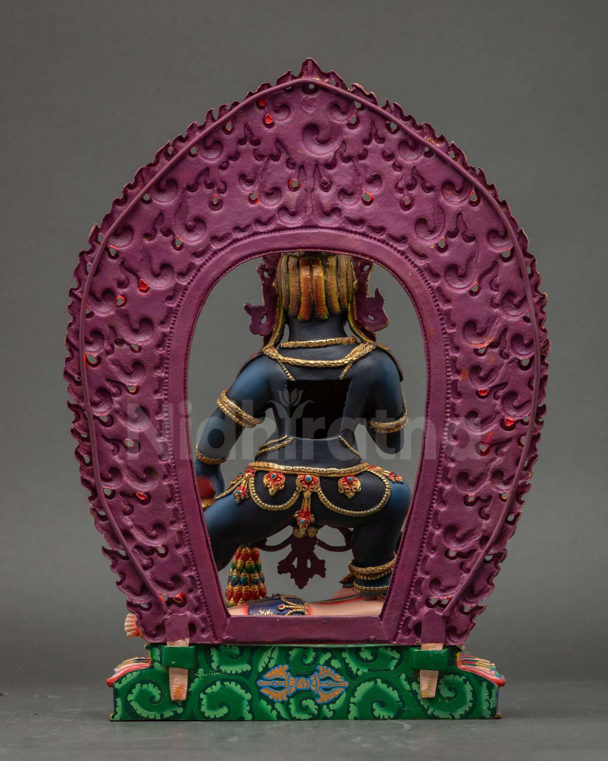 Back view of Black Dzambhala Statue with radiant flame halo and intricate details