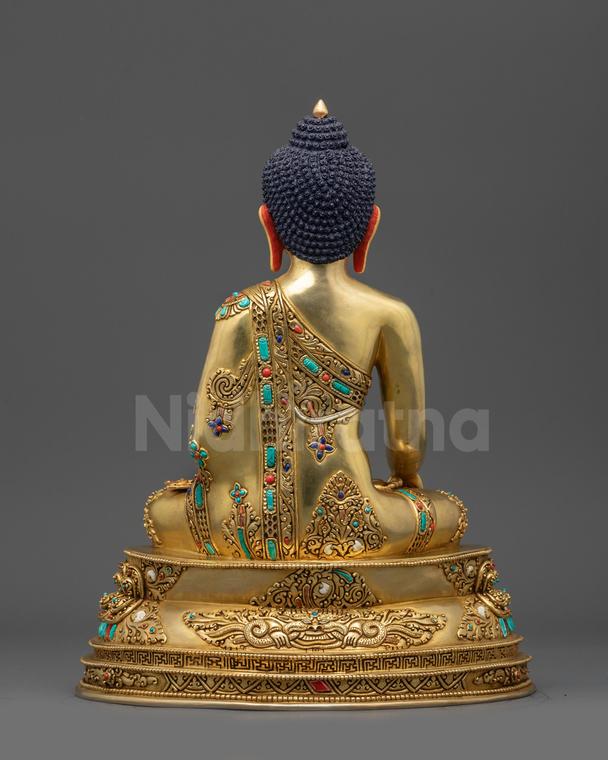 Back view of Buddha Shakyamuni statue highlighting Garuda head and double-lotus pedestal