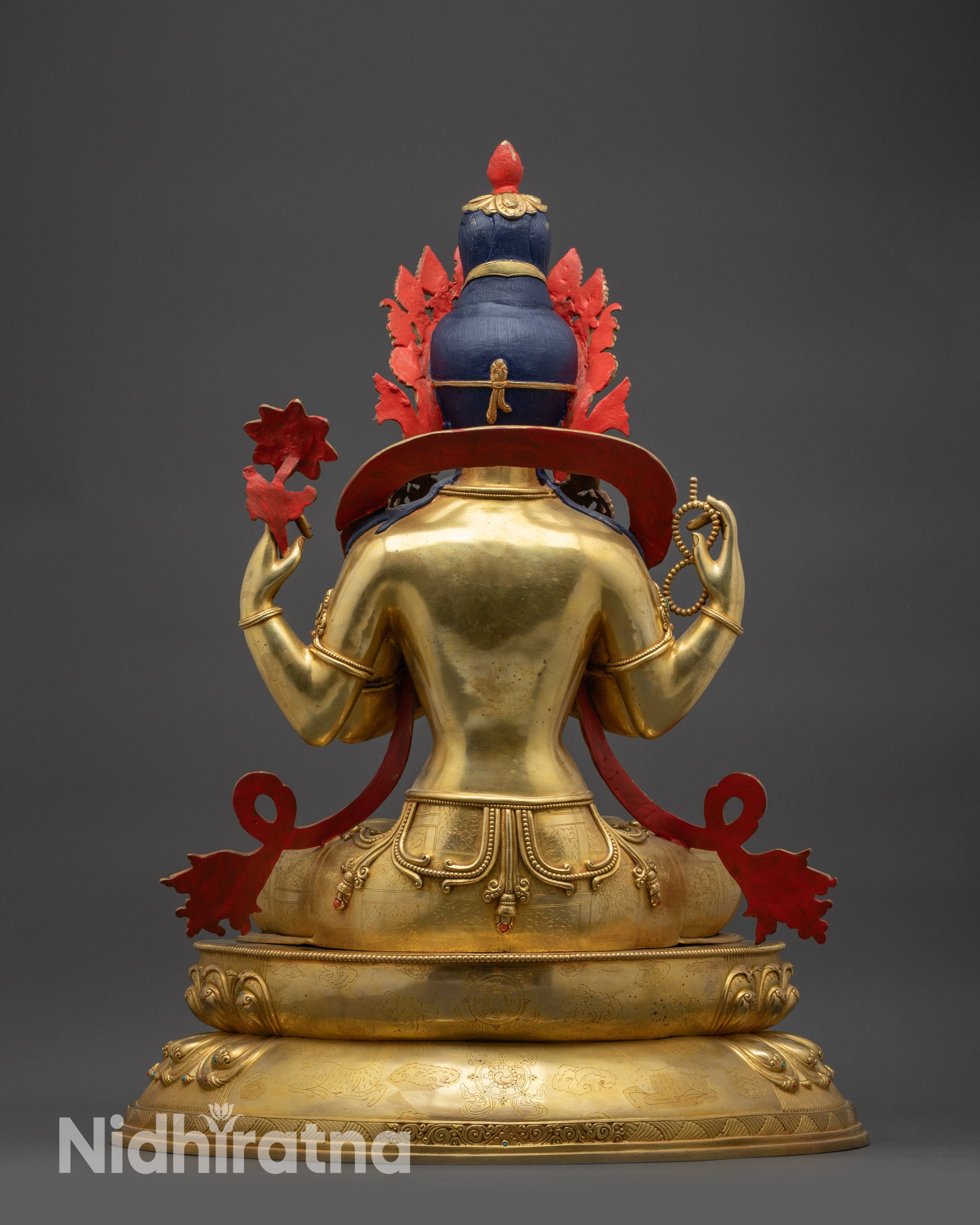 Back view of Chenrezig Statue showing carved robes and lotus base with deer