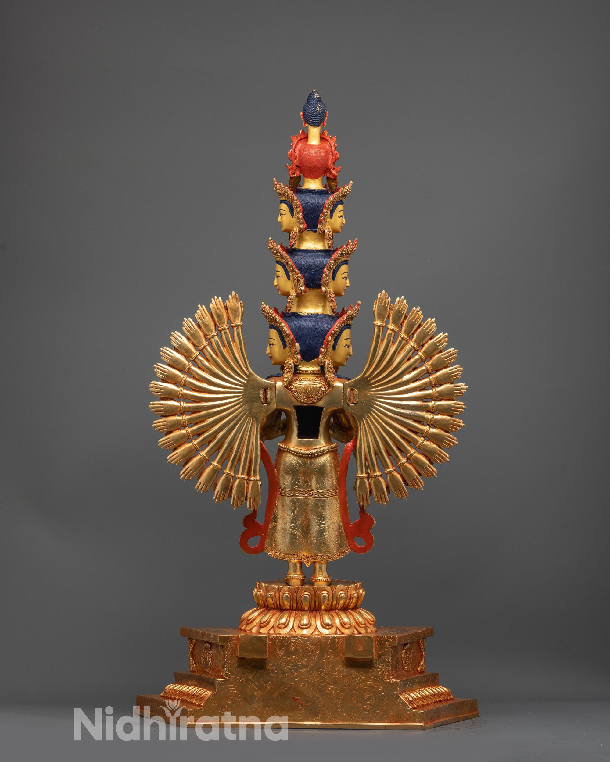 Back view of Chenrezig statue highlighting carved arms, eleven faces, and gold fire-gilded body
