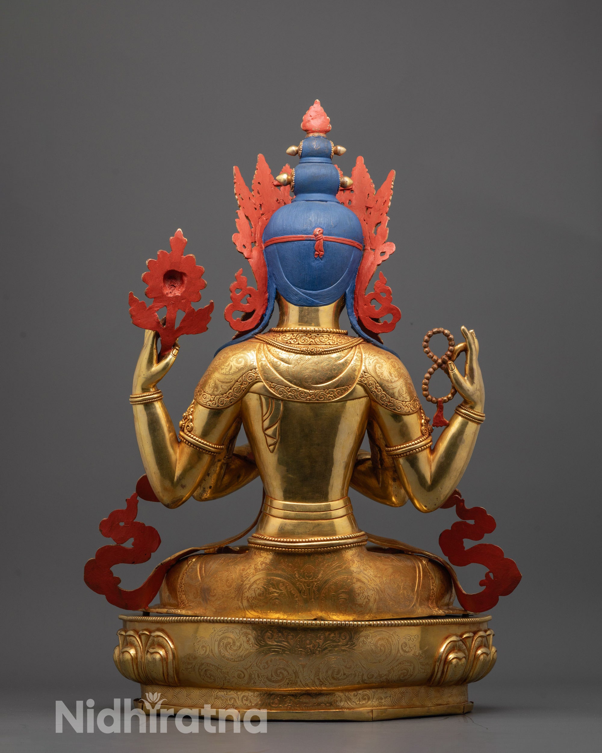 Back view of Chenrezig statue highlighting floating robe and intricate craftsmanship on copper base
