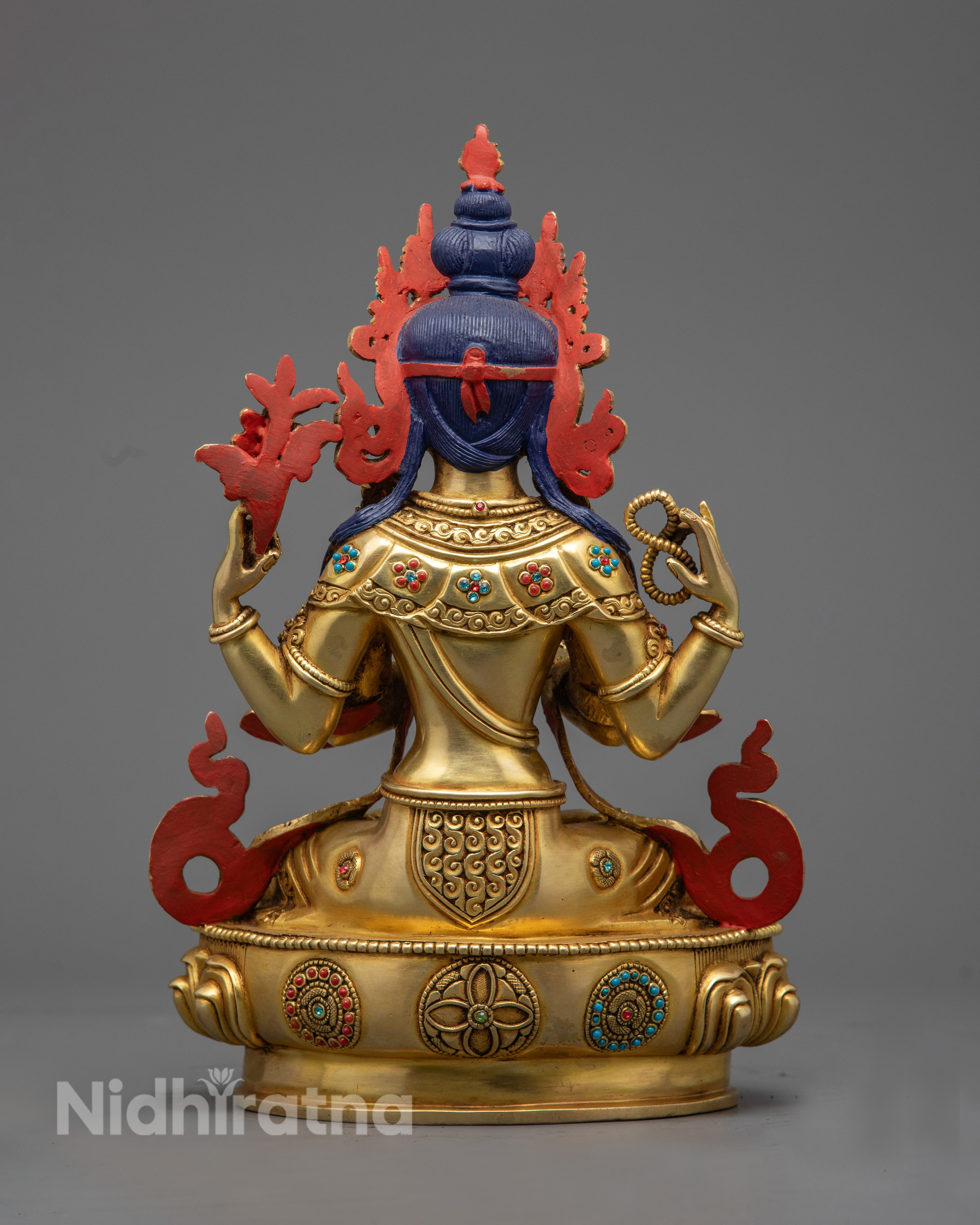 Chenrezig statue revealing the hollow mantra chamber and detailed lotus throne carvings by Nepalese artisans.