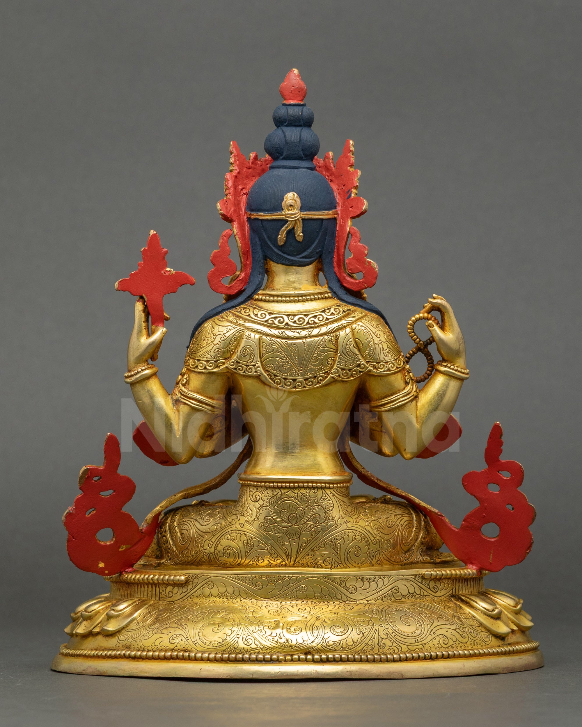 Back view of Chenrezig statue showing carved robes and lotus seat details