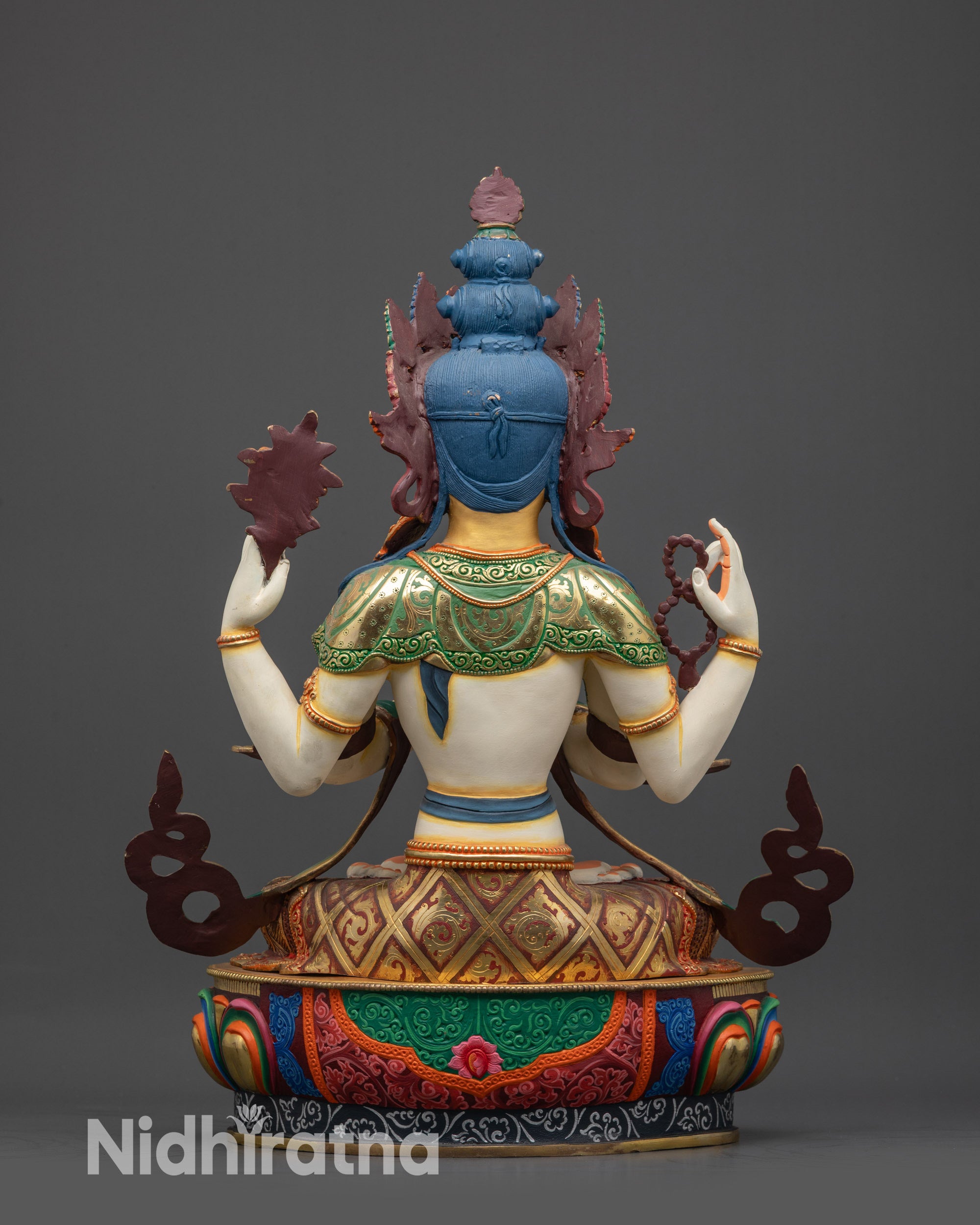 Back view of Chenrezig statue showing intricately carved lower garments and patterns
