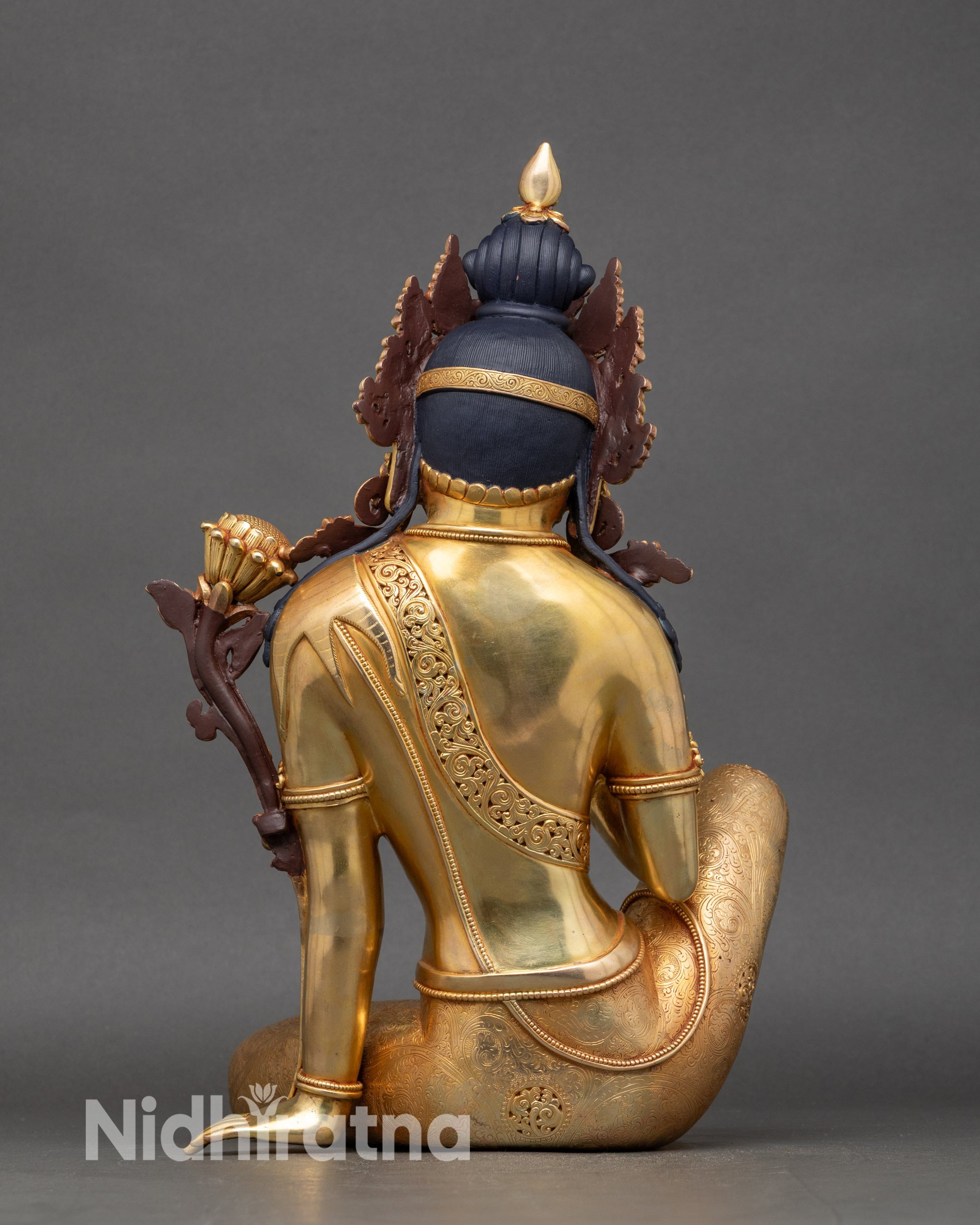 Back view of Chenrezig statue with detailed gold fire-gilded copper craftsmanship