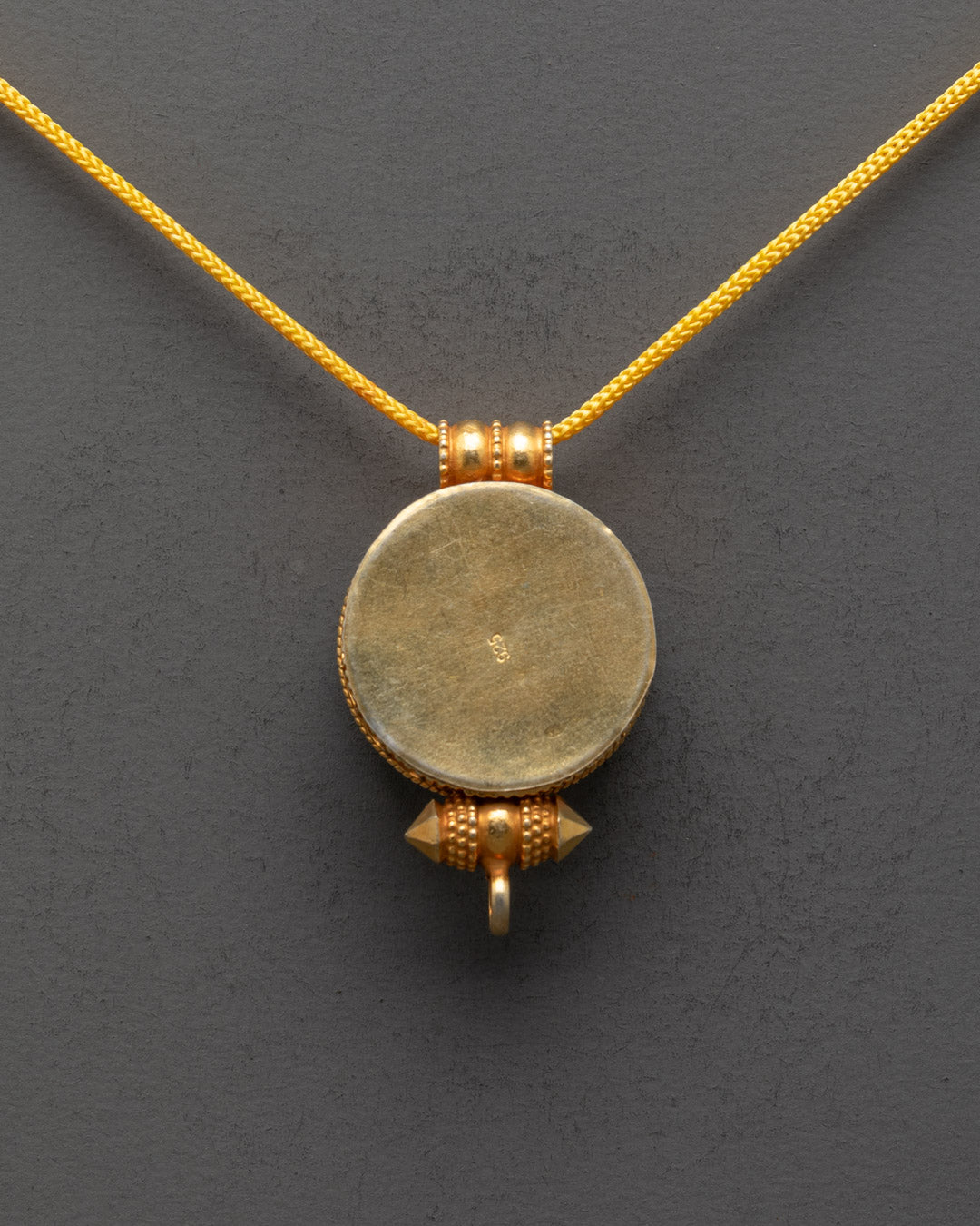Back view of Fish Design Ghau Pendant showcasing detailed patterns and artisan work