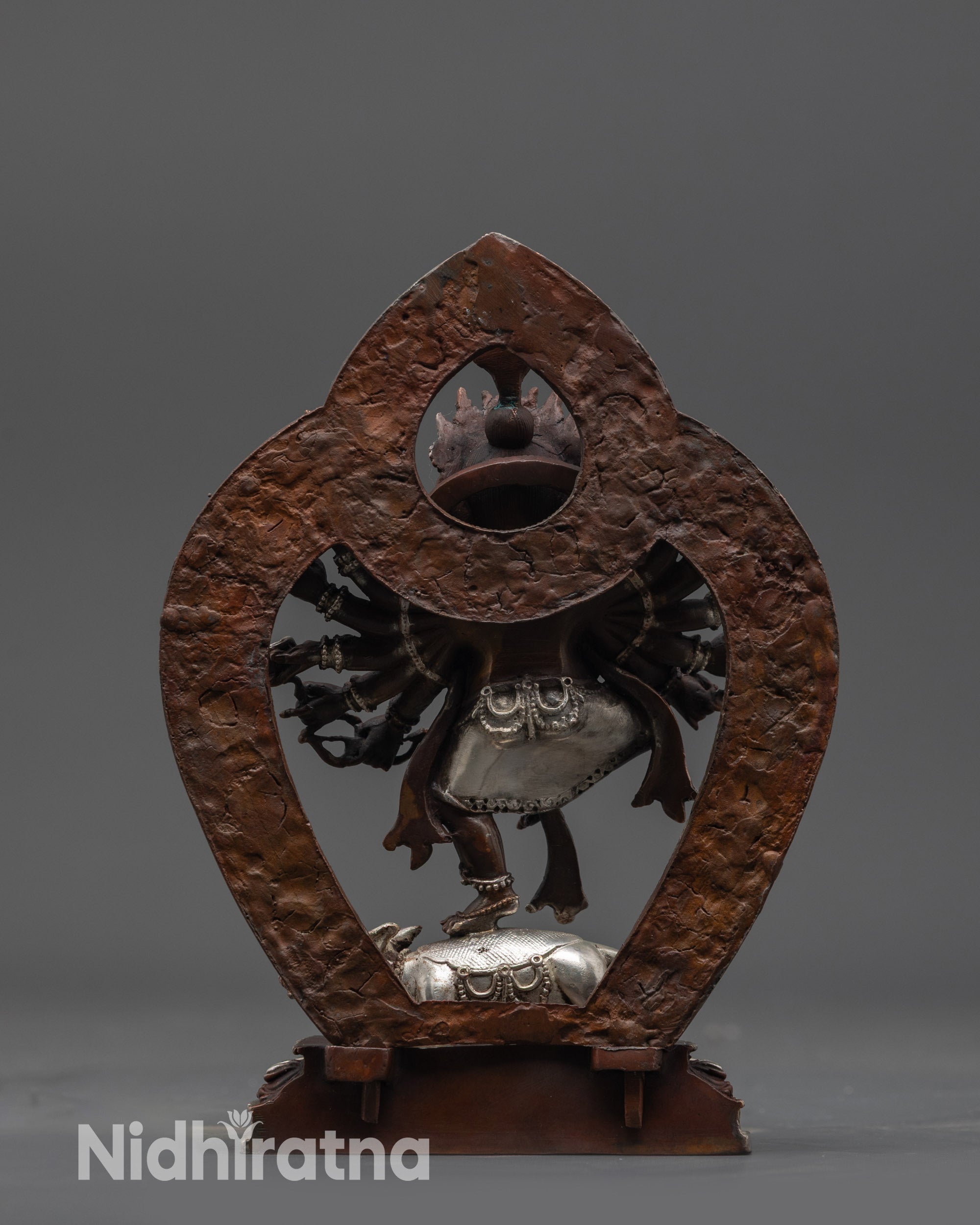 Back view of Ganesh Murti highlighting flowing robes and oxidized majestic halo
