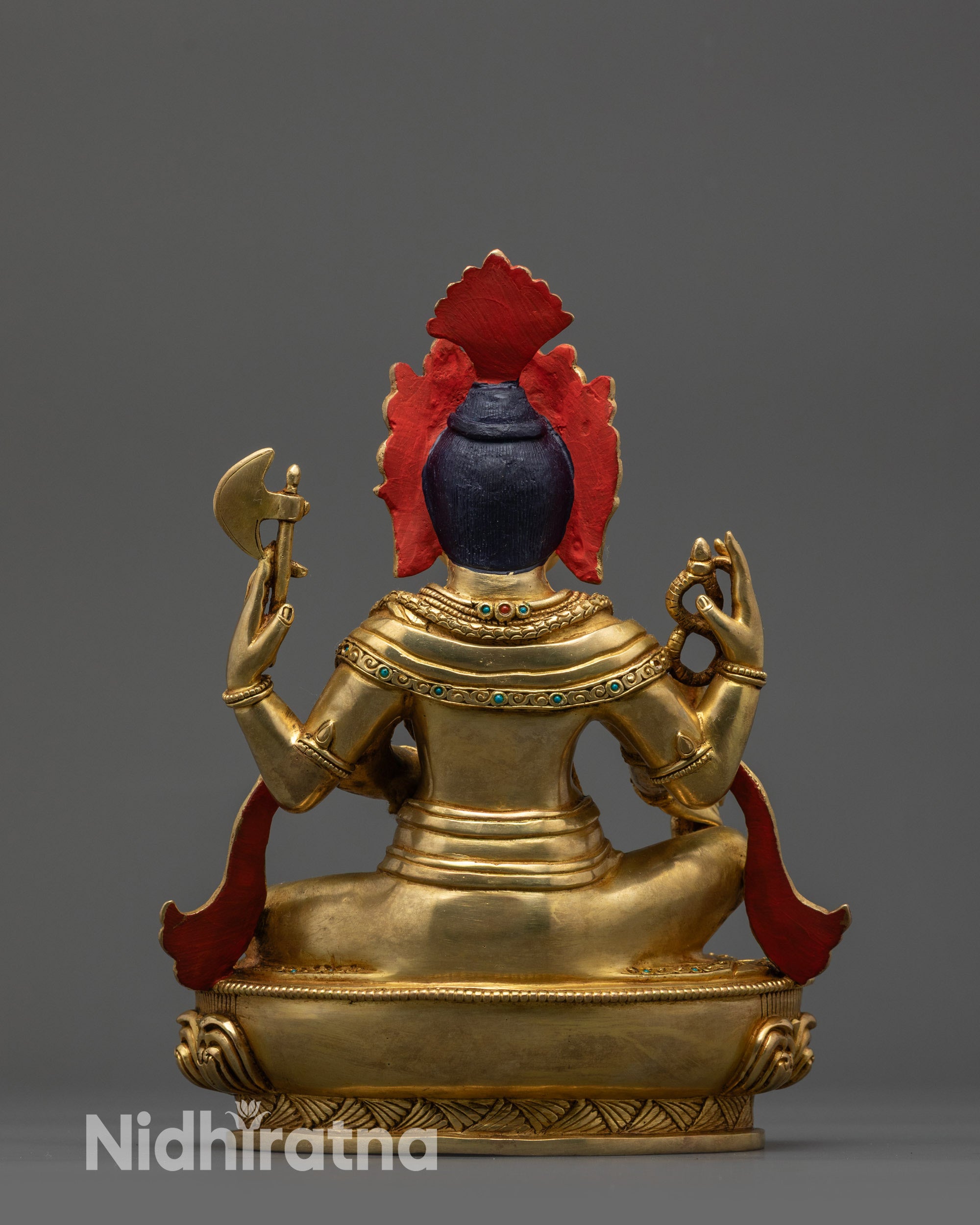 Back view of Ganesha statue with flowing robes and semi-precious stone details
