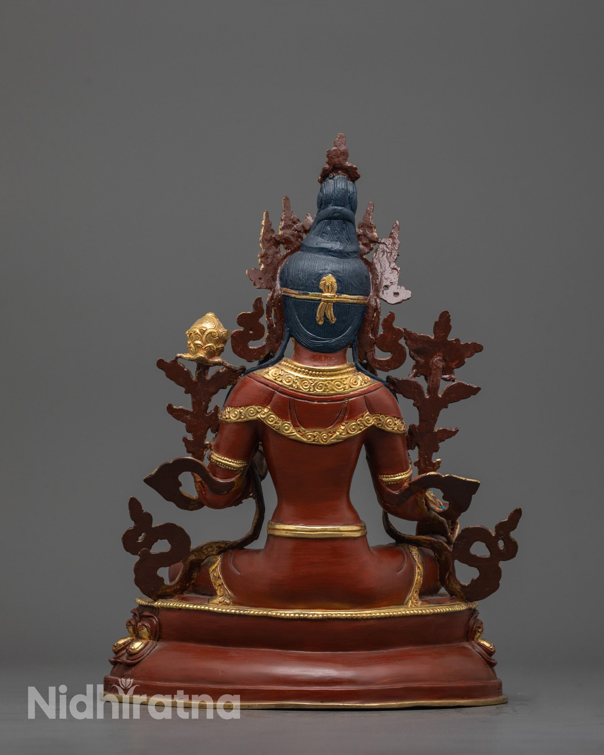 Back view of Green Tara Sculpture sitting gracefully on lotus seat, crafted by Nepalese artisan