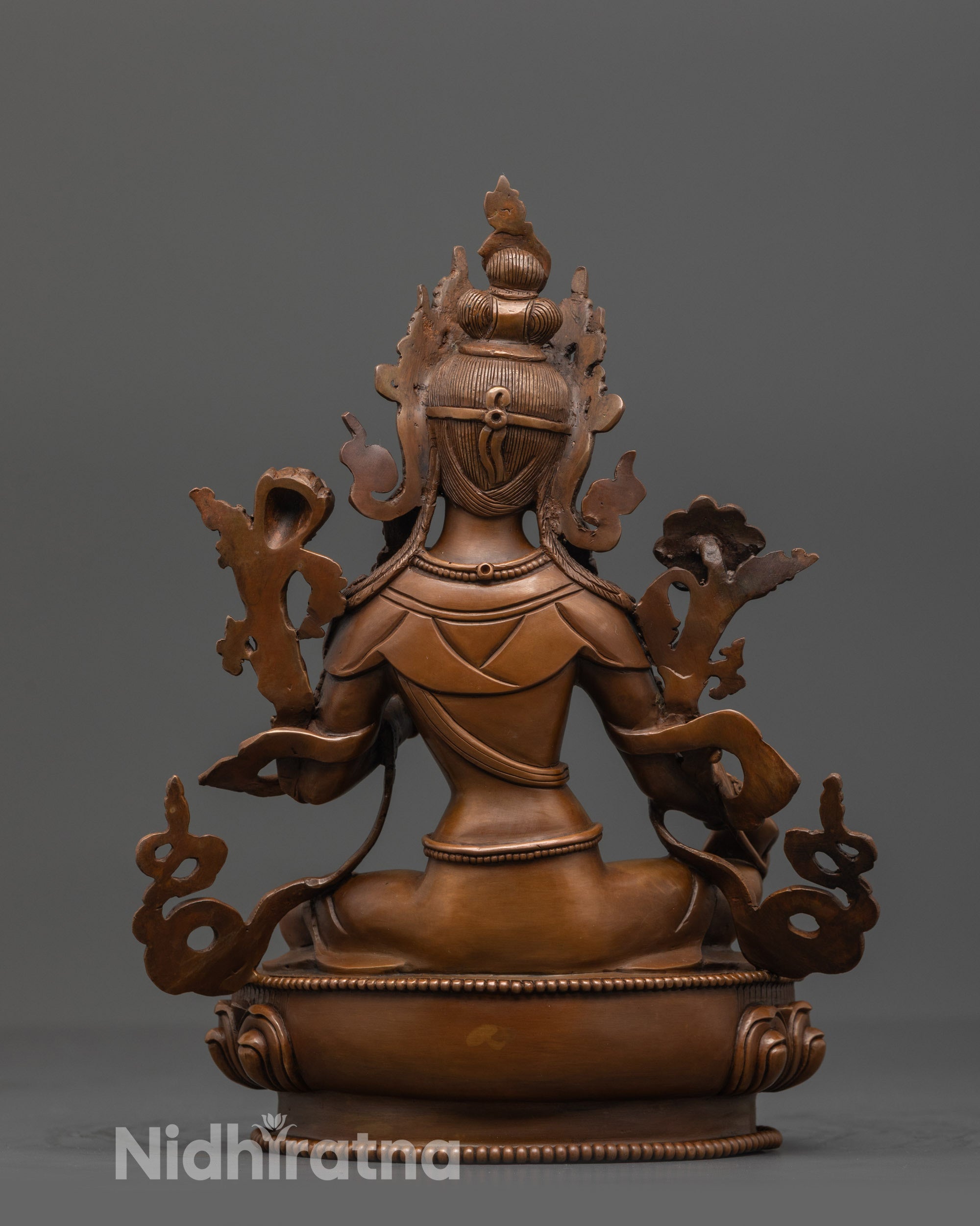 Back view of Green Tara Statue highlighting intricate patterns on robes and lotus seat