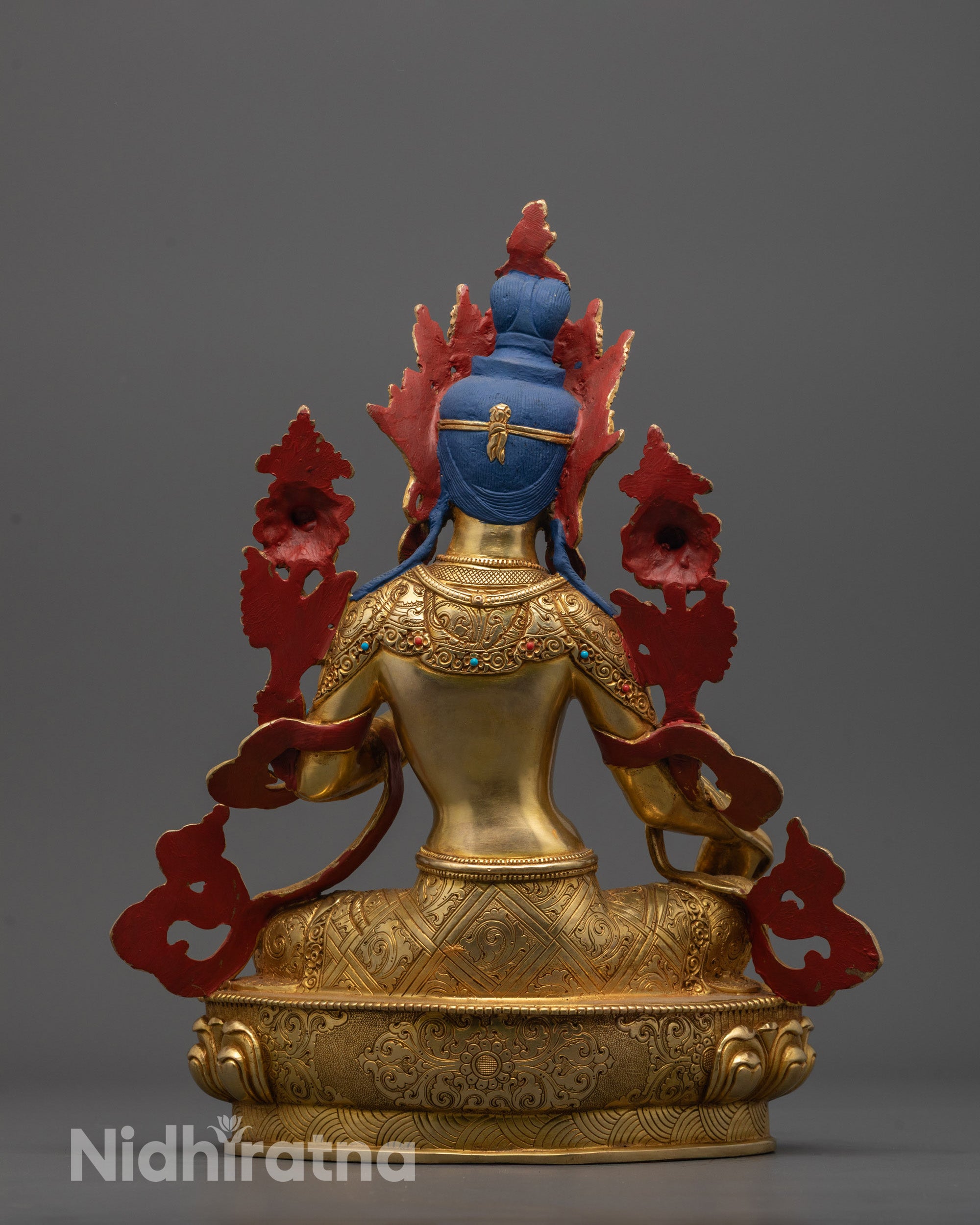 Back view of Green Tara Statue placed on meditation altar with spiritual decor
