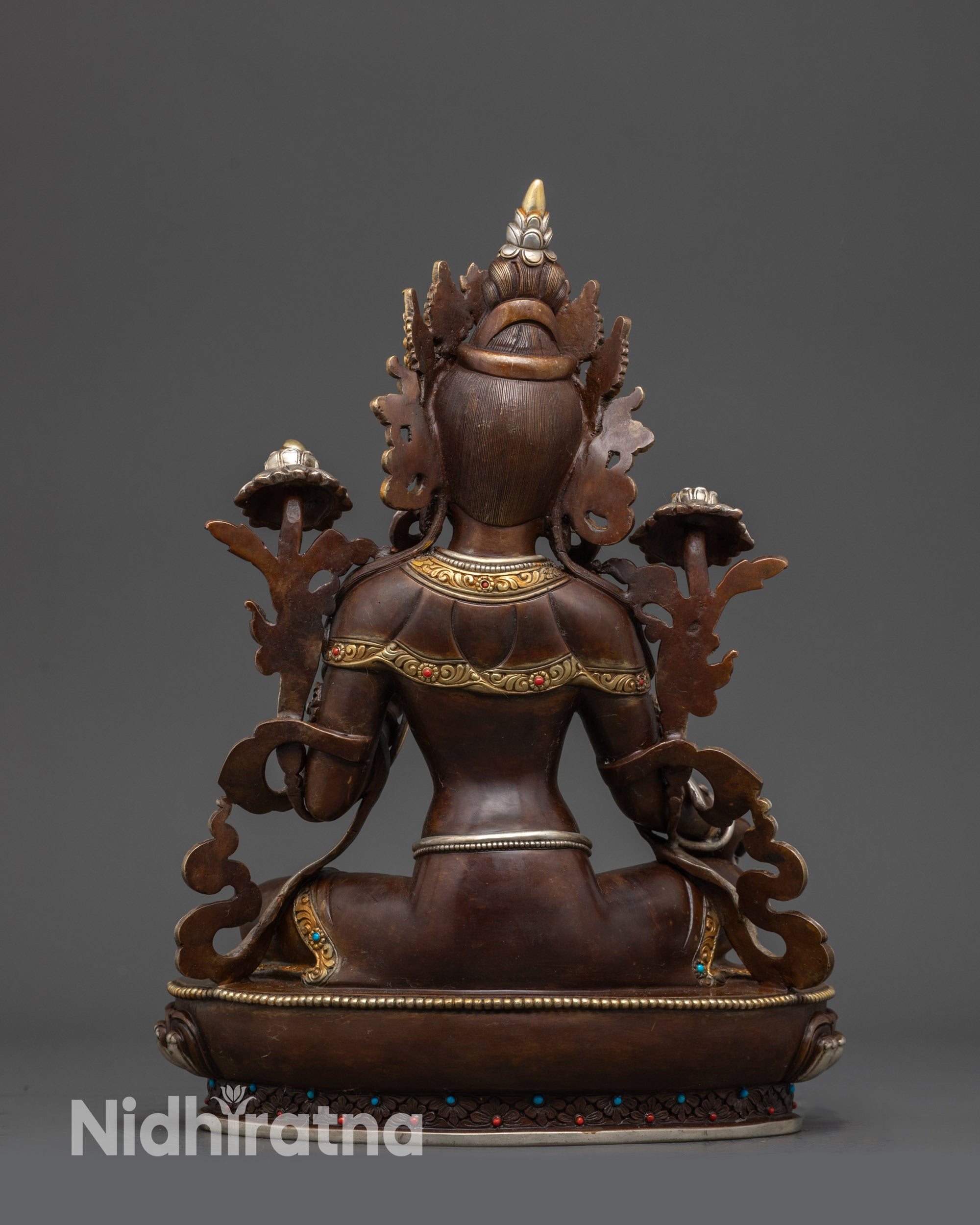 Back view of Green Tara Statue showing detailed robe and carved floral motifs