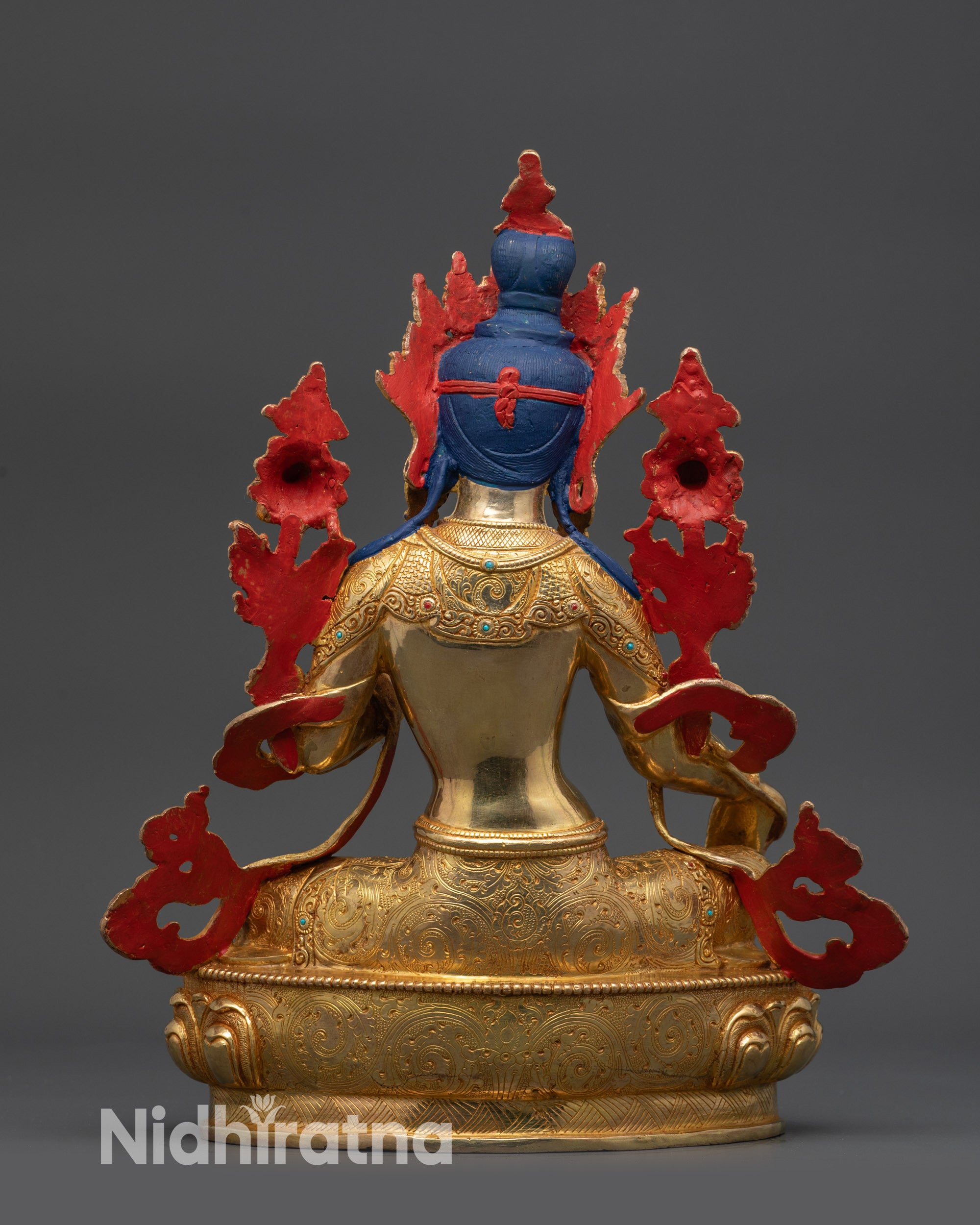 Back view of Green Tara statue highlighting carved robe and crown design