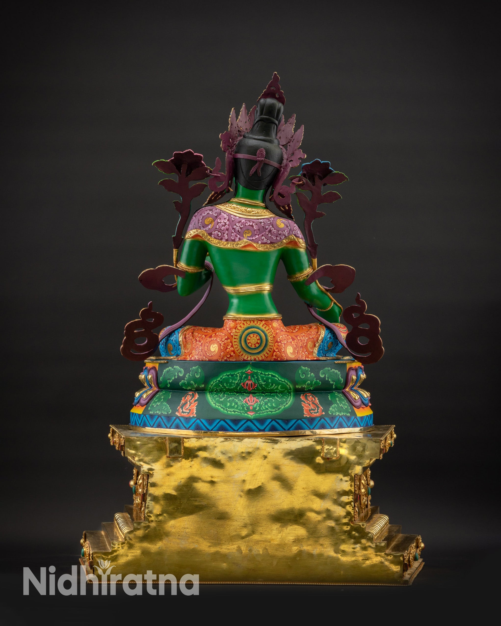 Back view of Green Tara statue on ornate hand-gilded Tibetan throne