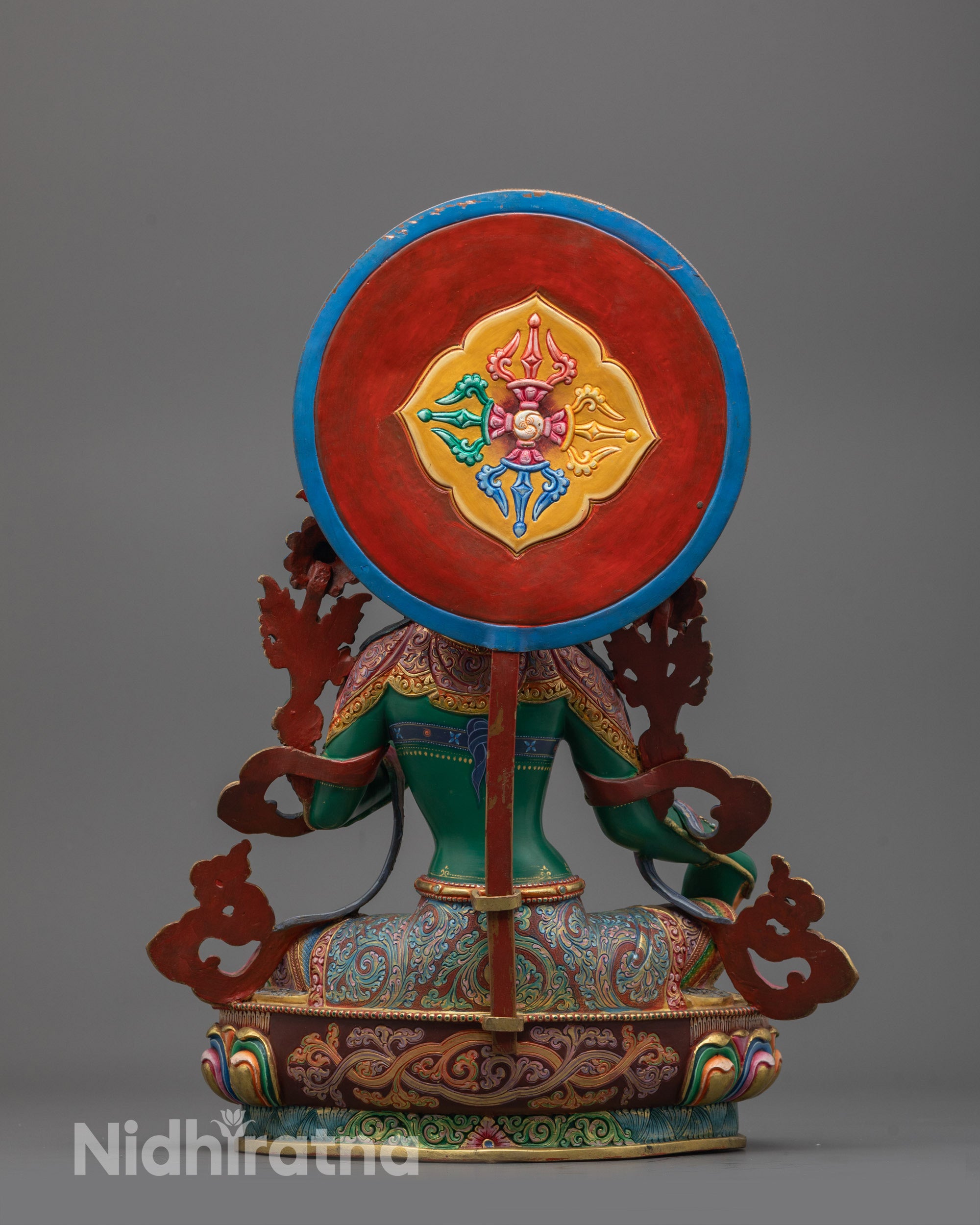 Back view of Green Tara statue showcasing detailed robe patterns and blooming lotus throne