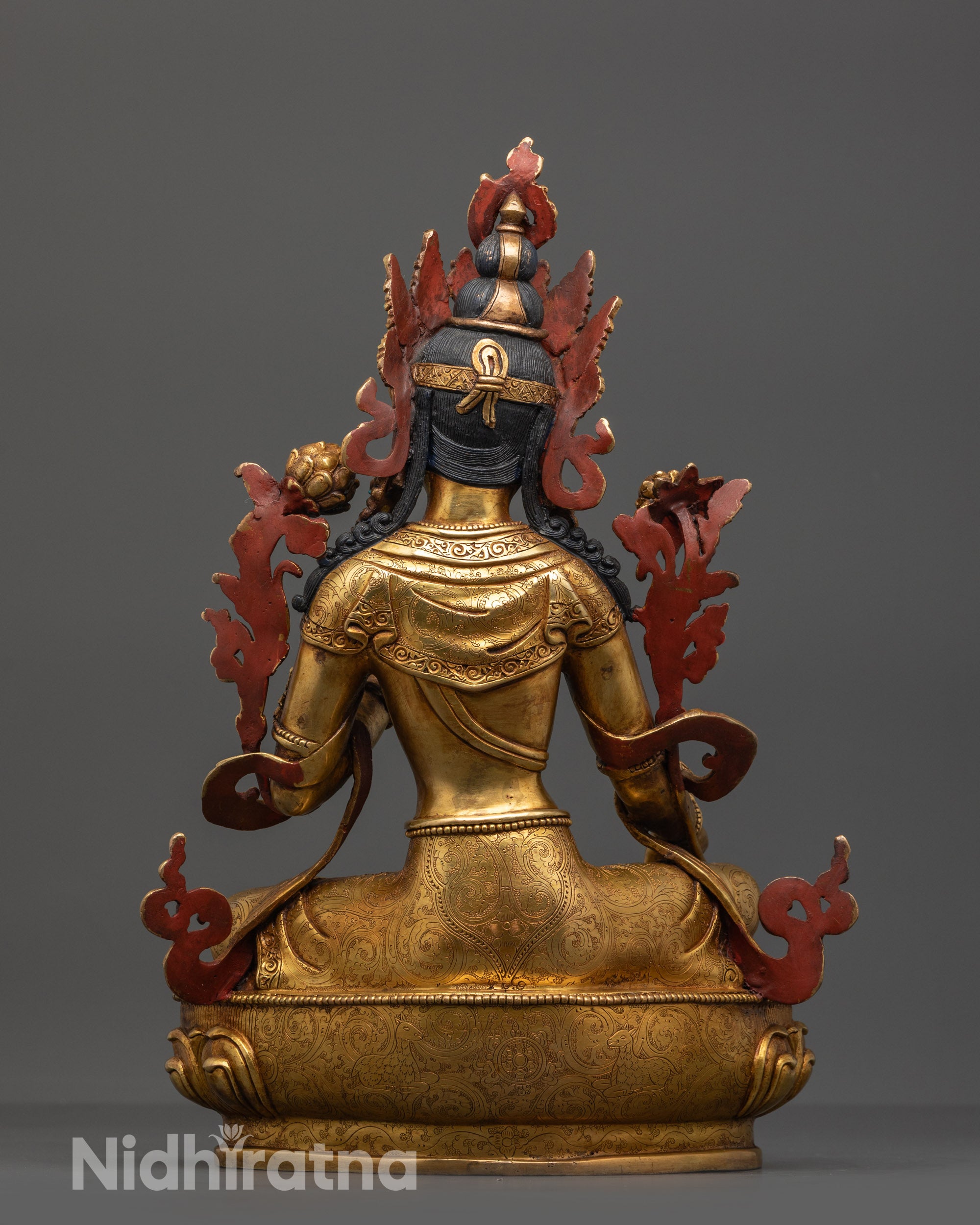 Back view of Green Tara statue showing intricate robe patterns and gold fire-gilded body