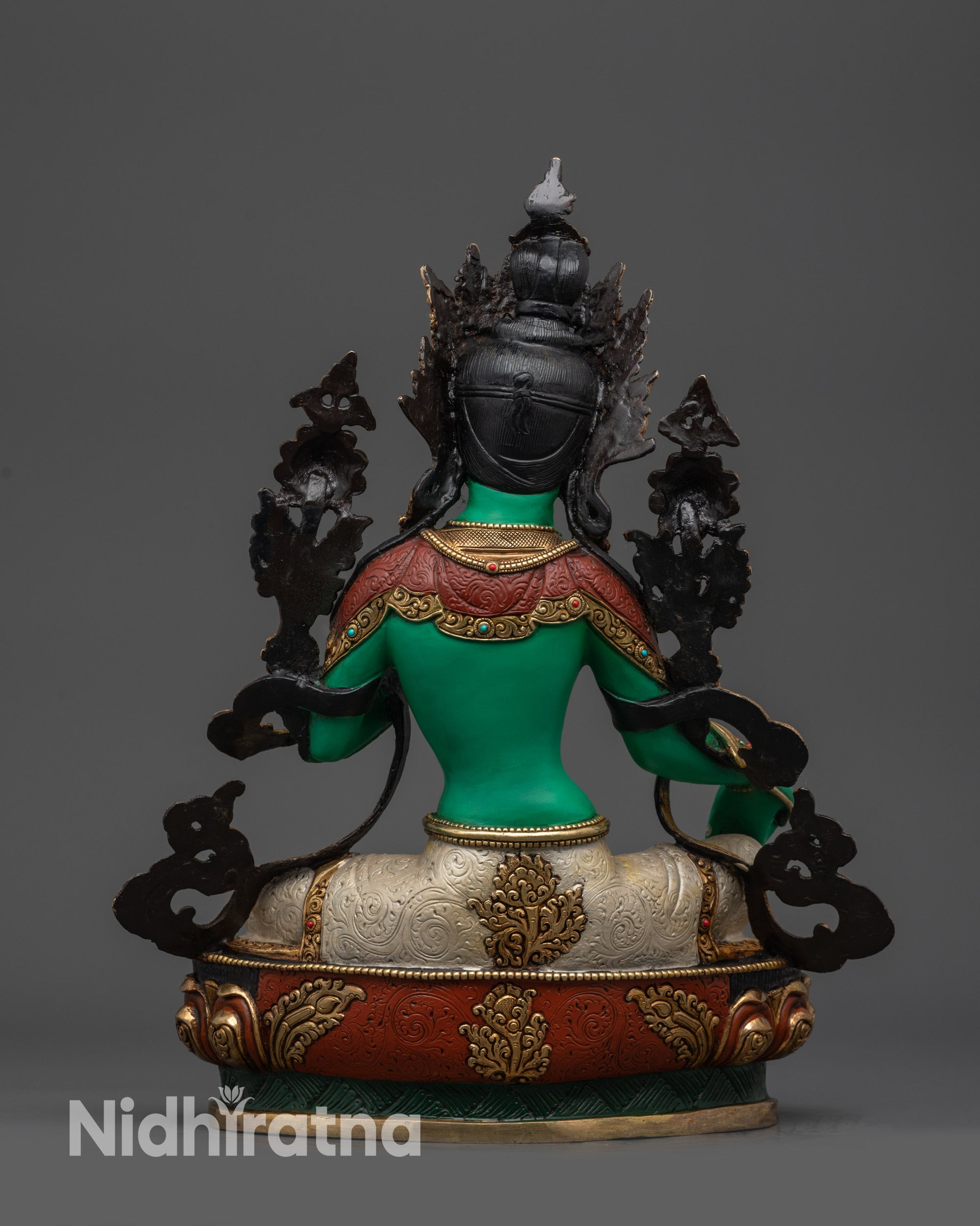 Back view of Green Tara statue showing robe folds and lotus pedestal