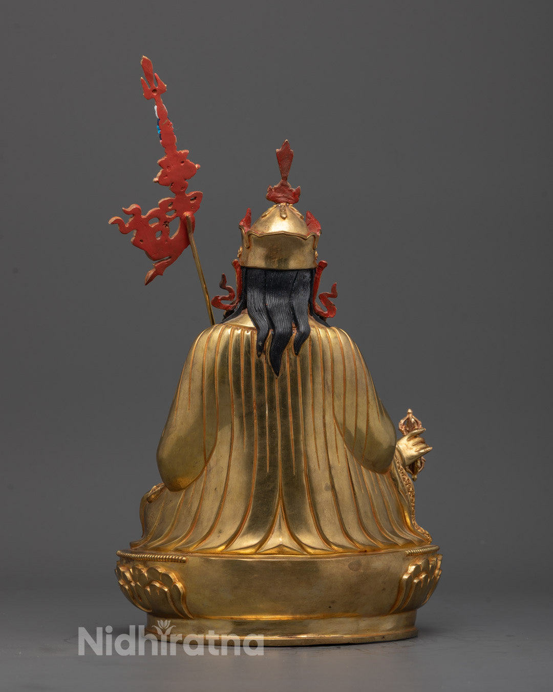 Back view of Guru Padmasambhava Statue displaying intricate carvings and lotus throne.