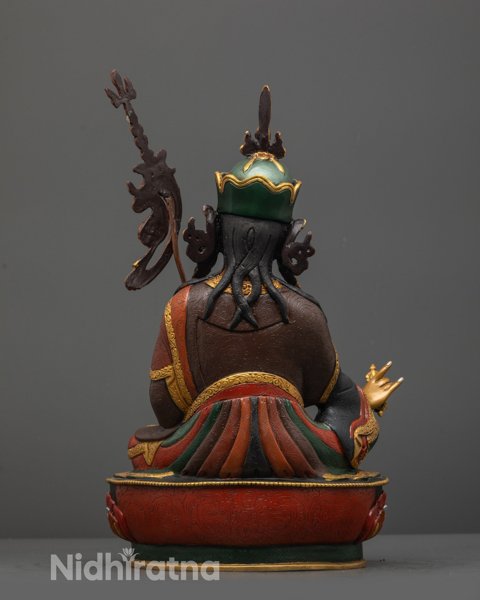 Back view of Guru Padmasambhava statue highlighting gold-plated lotus base and vibrant colors