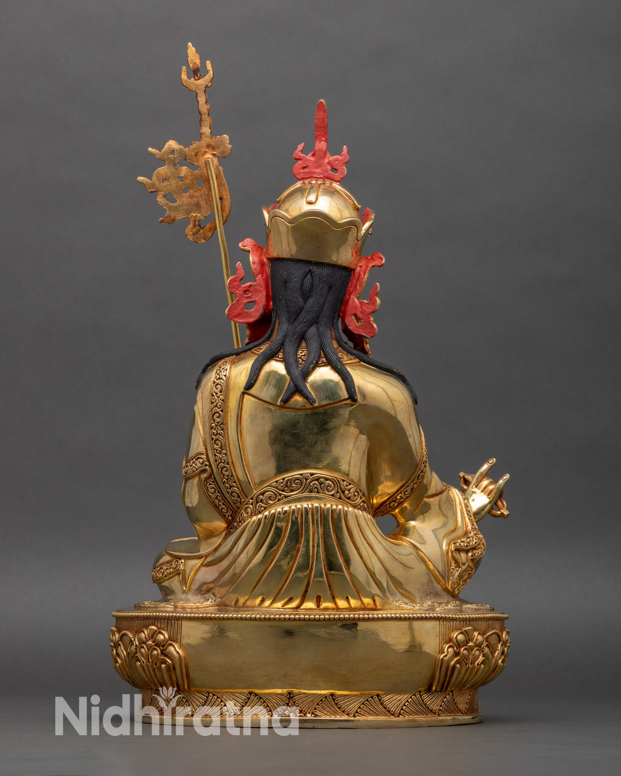 Back view of Guru Padmasambhava statue with flowing robes and lotus pedestal