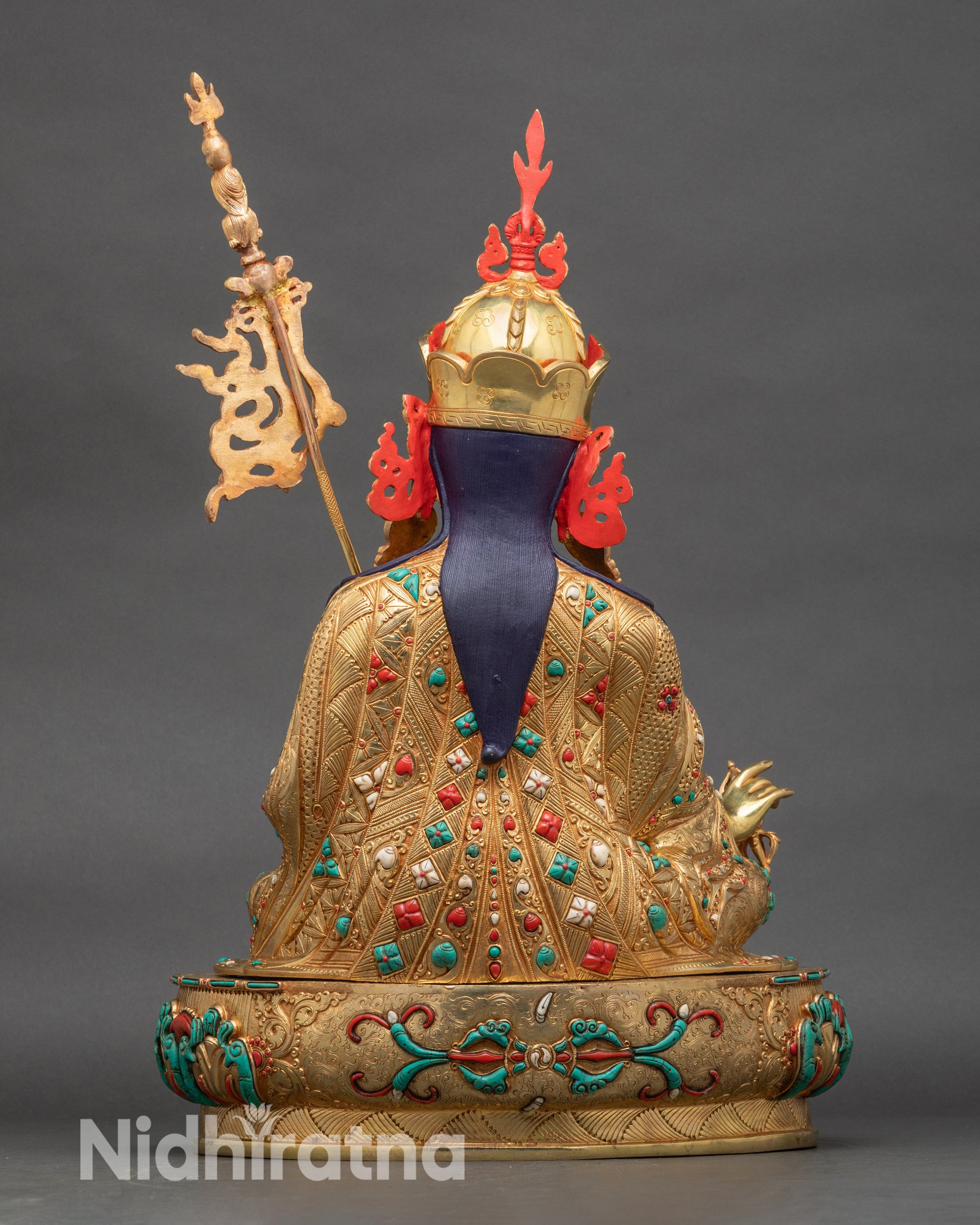 Back view of Guru Rinpoche sculpture, detailed lotus pedestal and flowing robes with sacred craftsmanship
