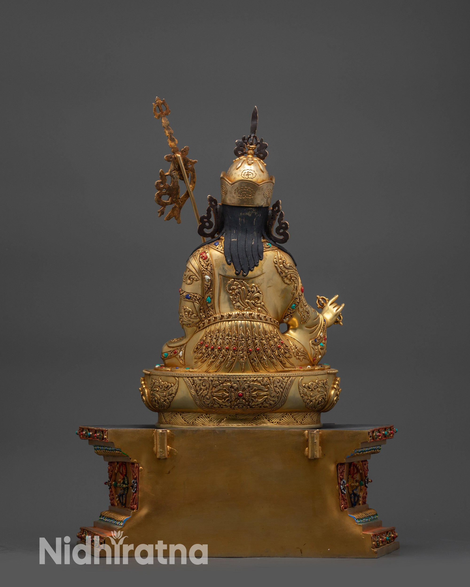 Back view of Guru Rinpoche statue showing throne and detailed garments