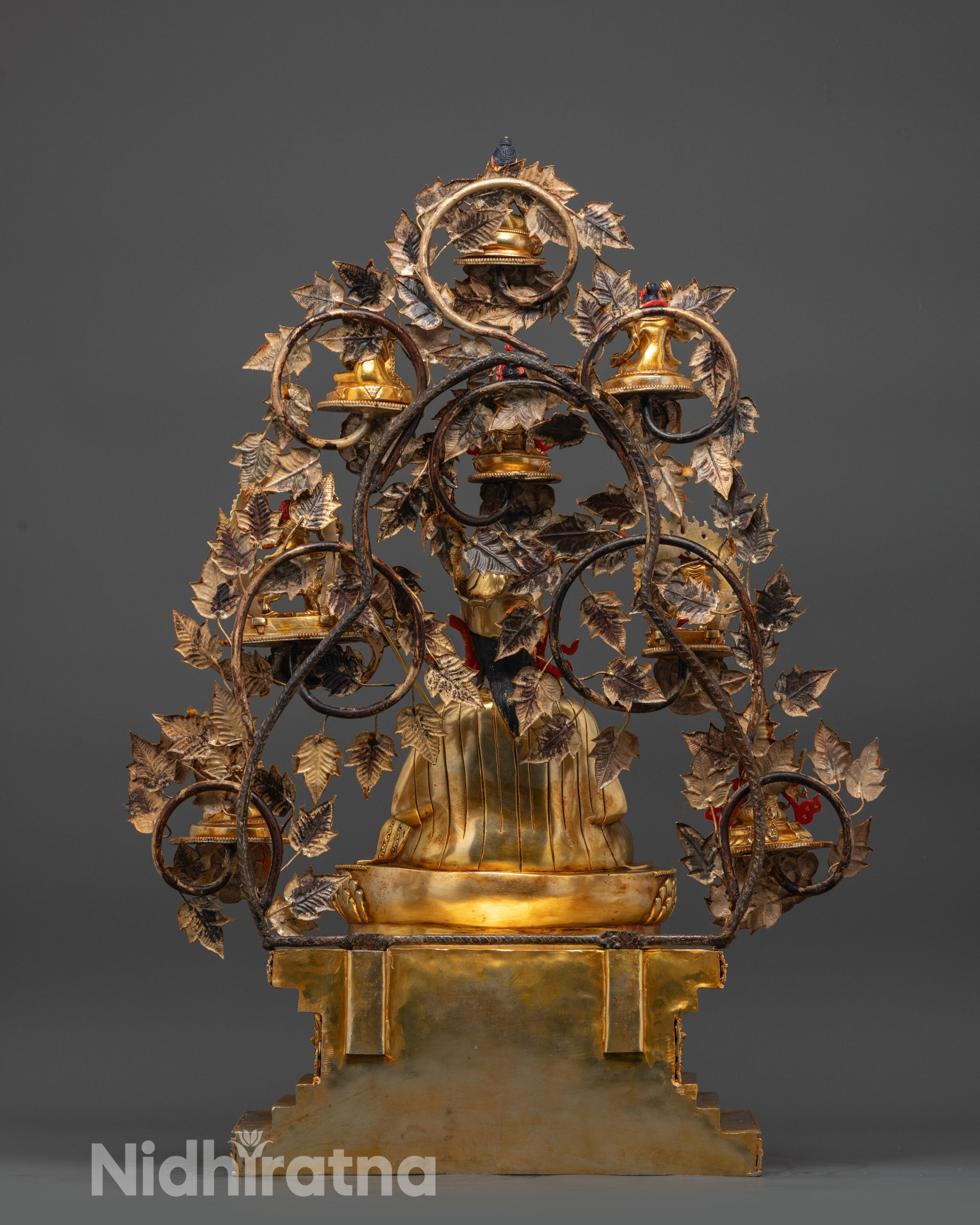 Back view of Guru Sangey Statue with lotus seat, robes, and tree-like manifestation arrangement