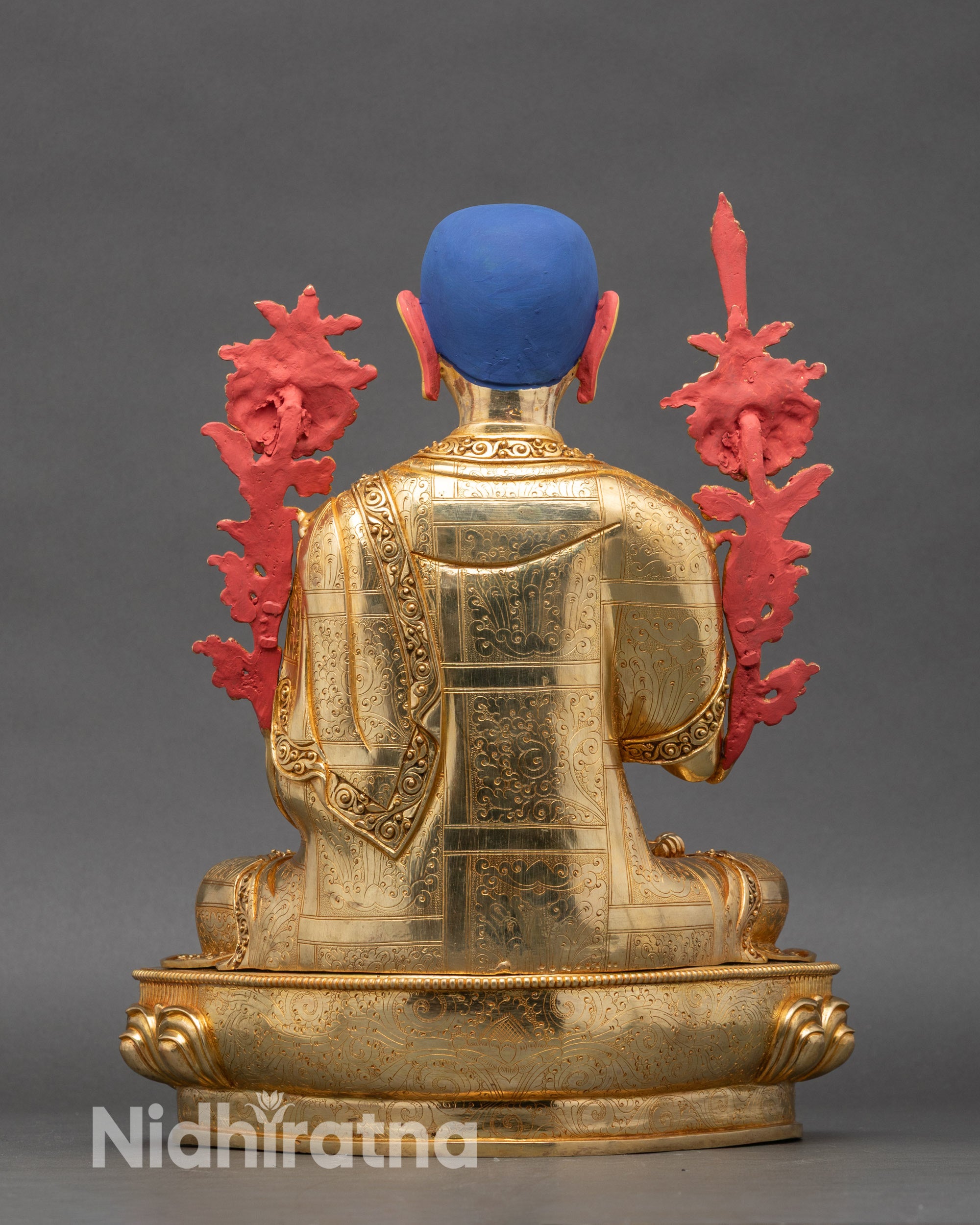 Back view of Je Tsongkhapa copper statue showing lotus base and engraved details