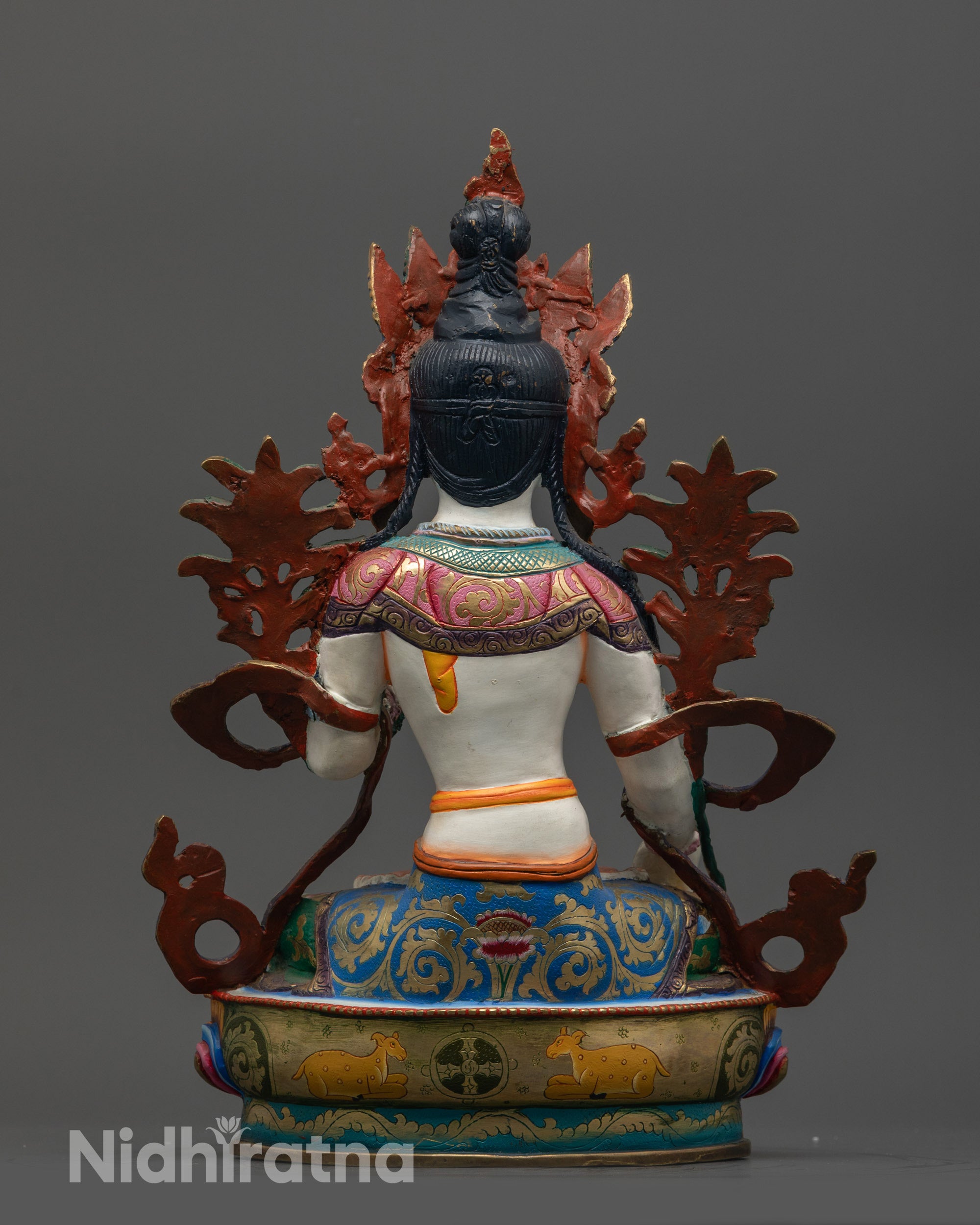 Back view of Jetsun Drolma showing carved lotus pedestal and intricate robe patterns