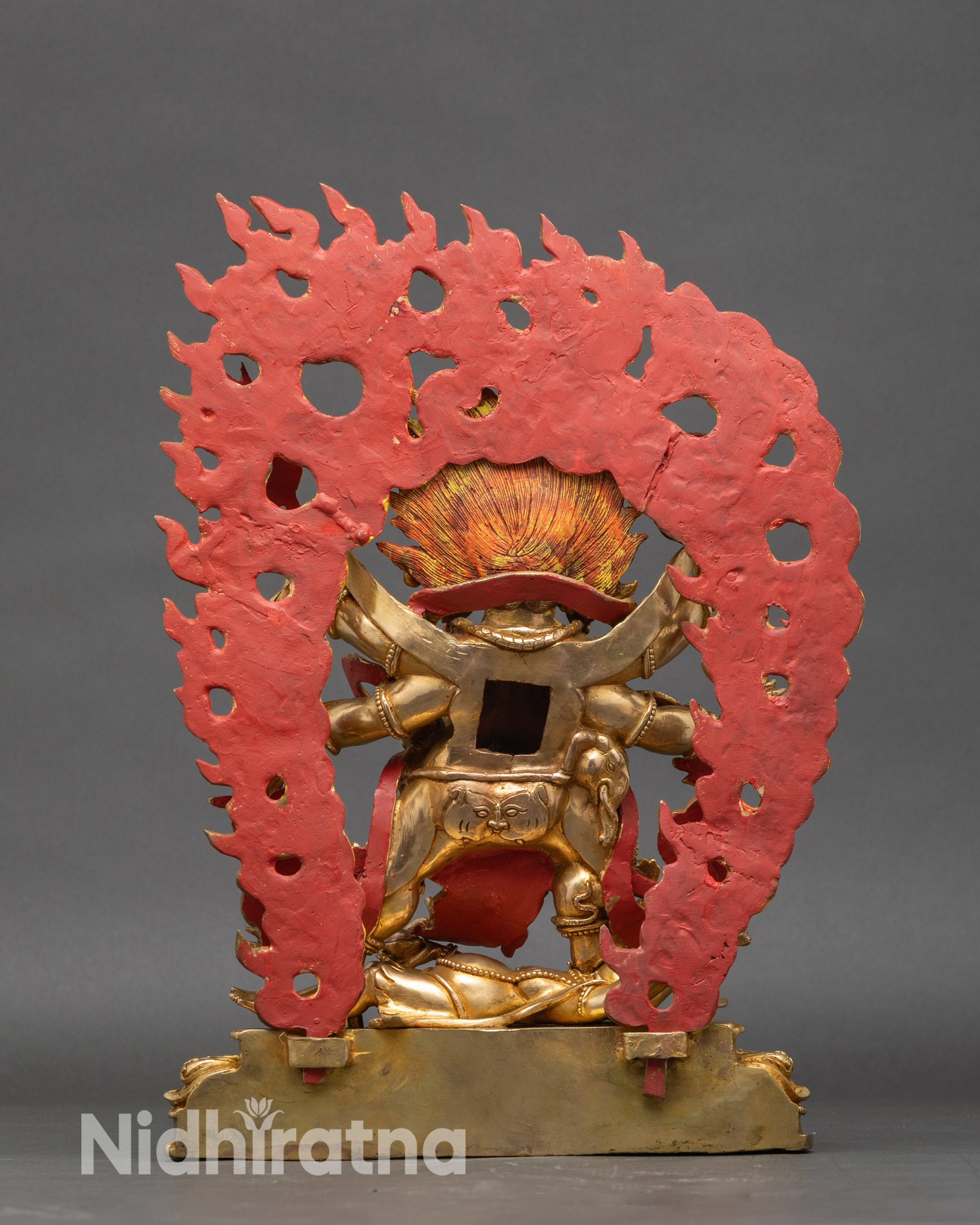 Back view of Mahakala statue with hand-painted flame halo and detailed robe