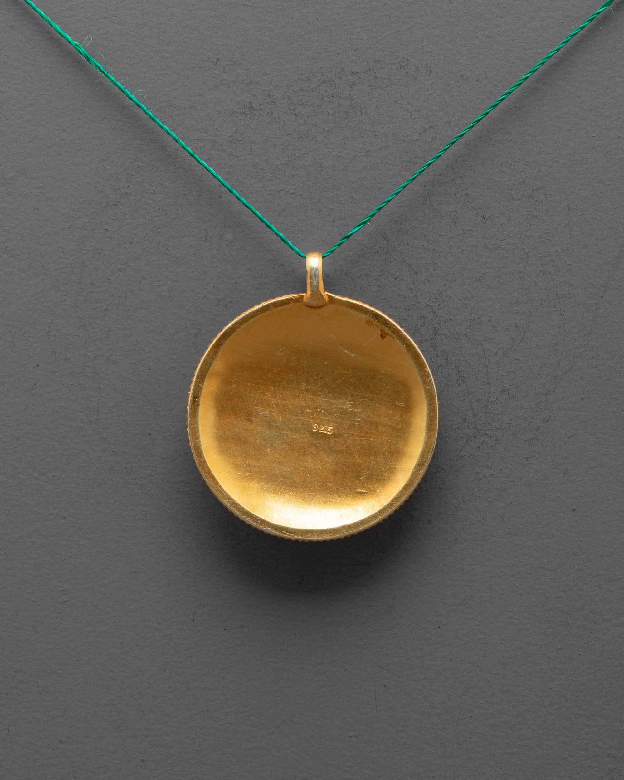 Back view of Mandala Locket showing gold-plated copper and fine filigree craftsmanship