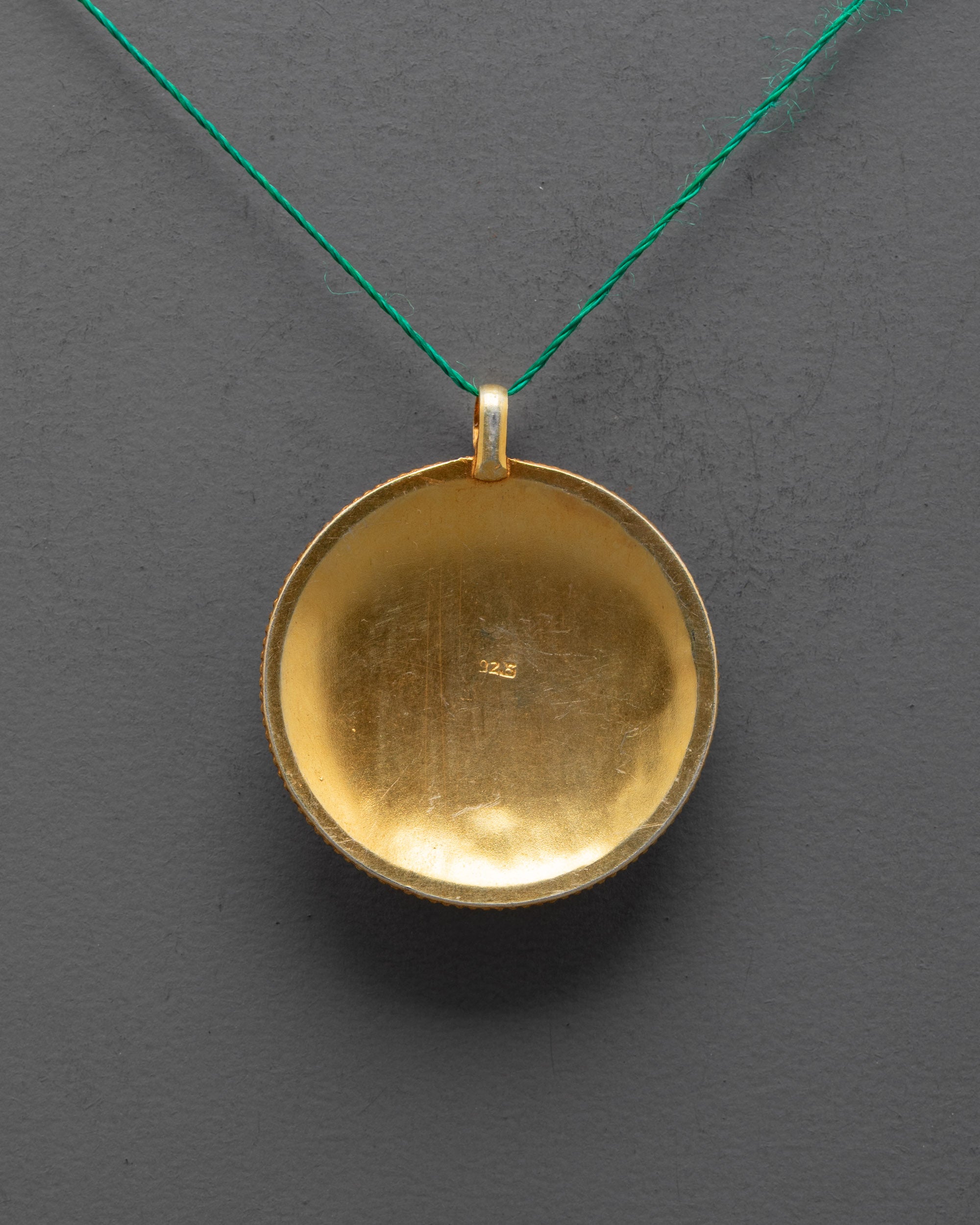 Back view of Mandala Pendant highlighting traditional craftsmanship and delicate carving