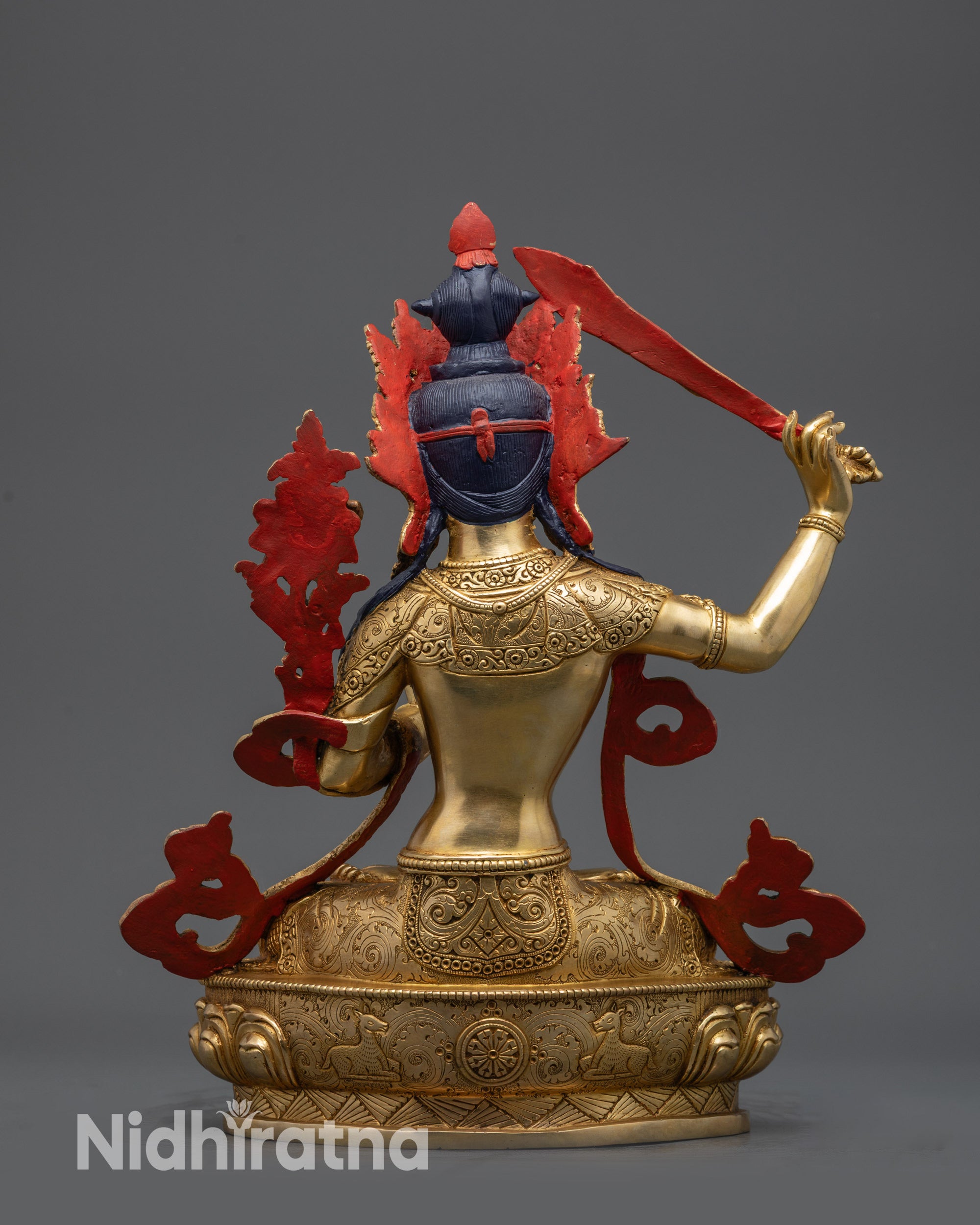 Back view of Manjushri Statue showing gold fire-gilded copper base and lotus carvings