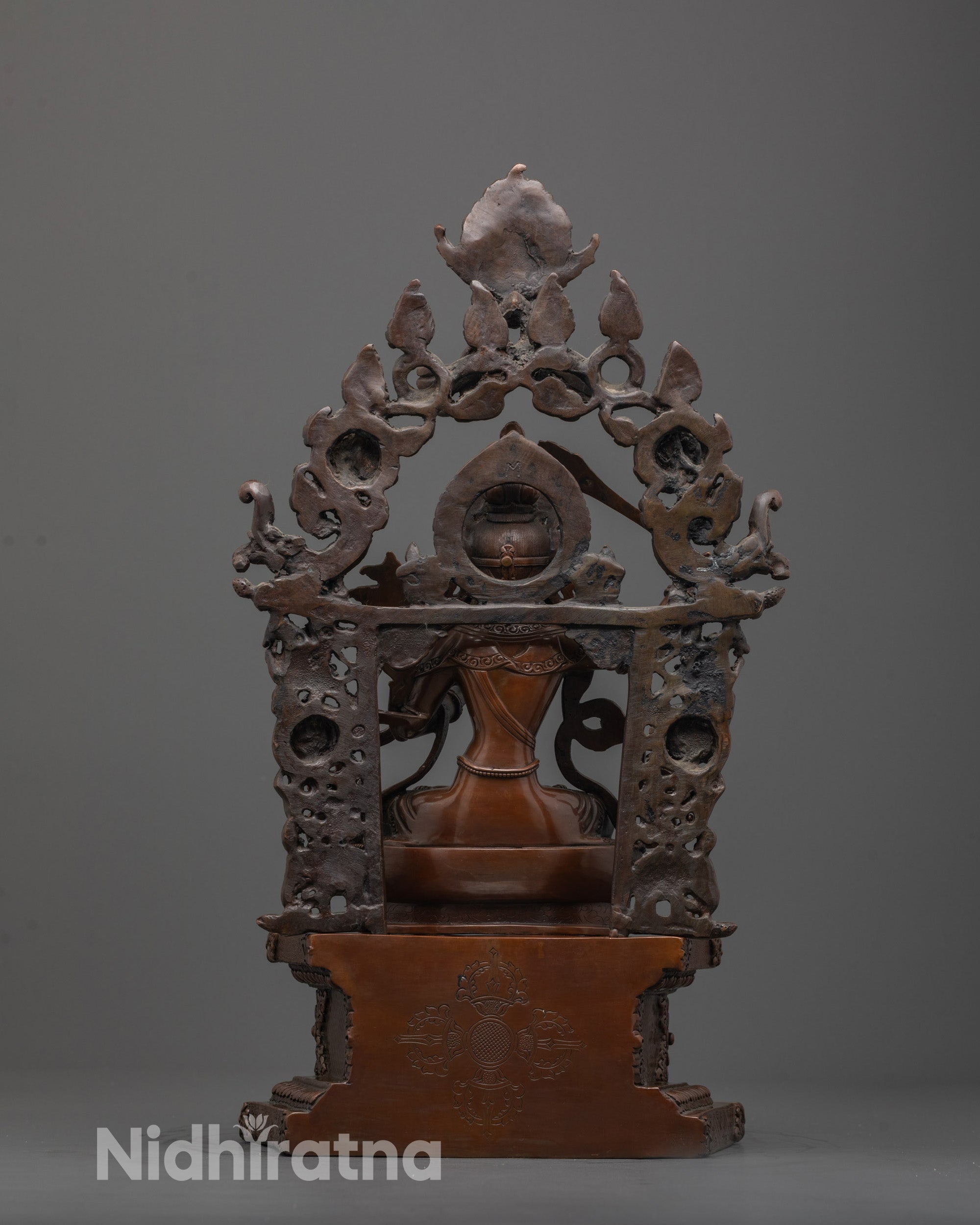 Back view of Manjushri statue highlighting detailed craftsmanship and oxidized copper finish