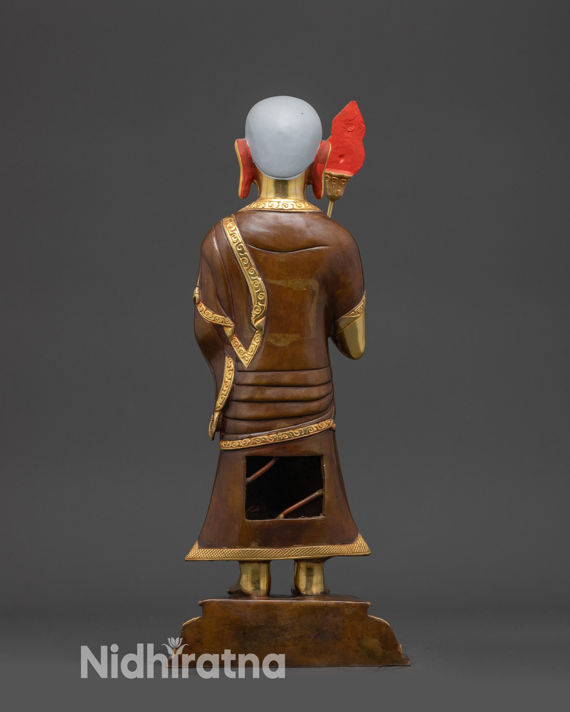 Back view of Maudgalyayana disciple statue showing traditional robe carvings