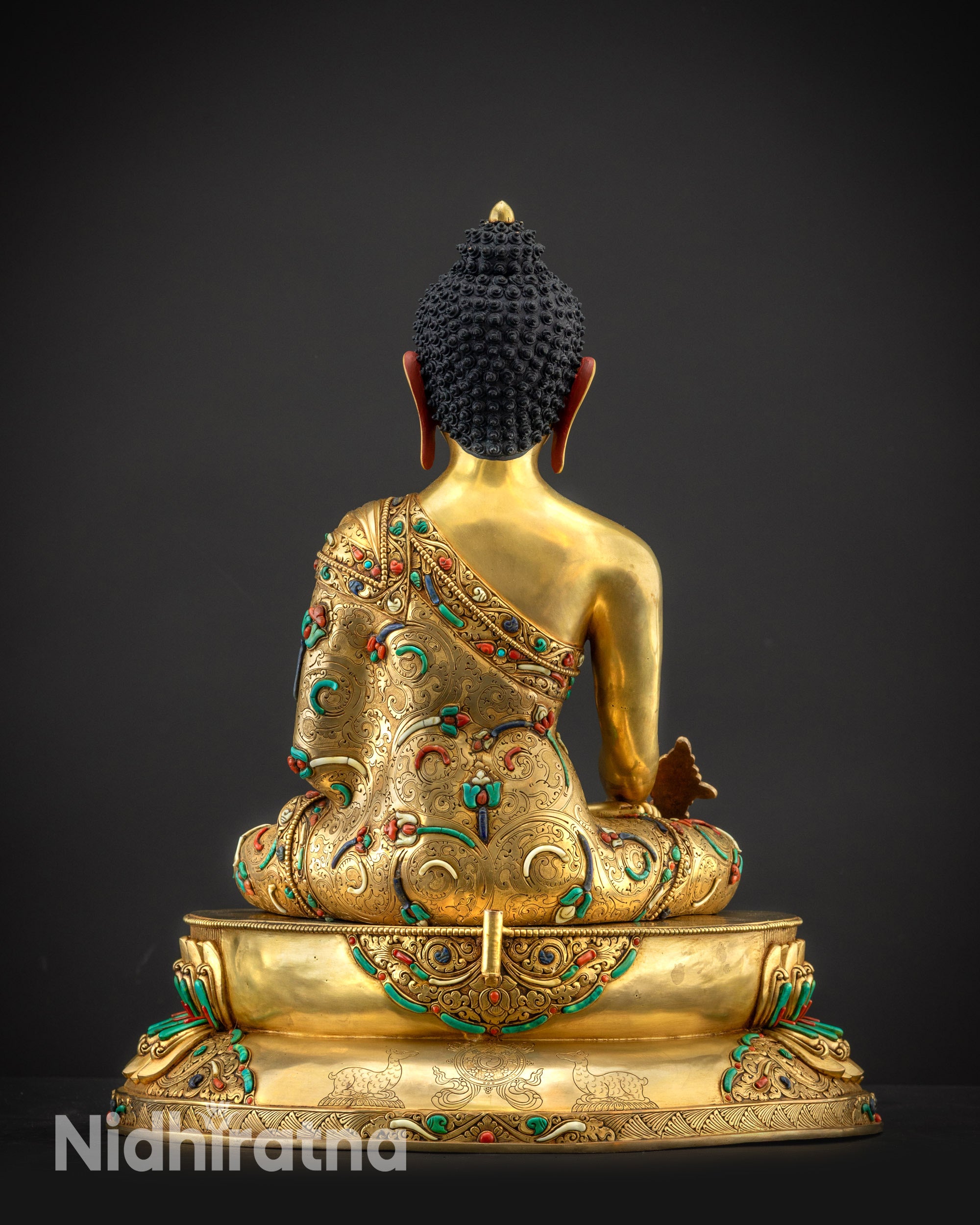 Back view of Medicine Buddha without halo showing carved robes and lotus seat details clearly